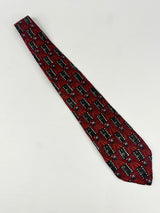 Red patterned tie on a light gray background