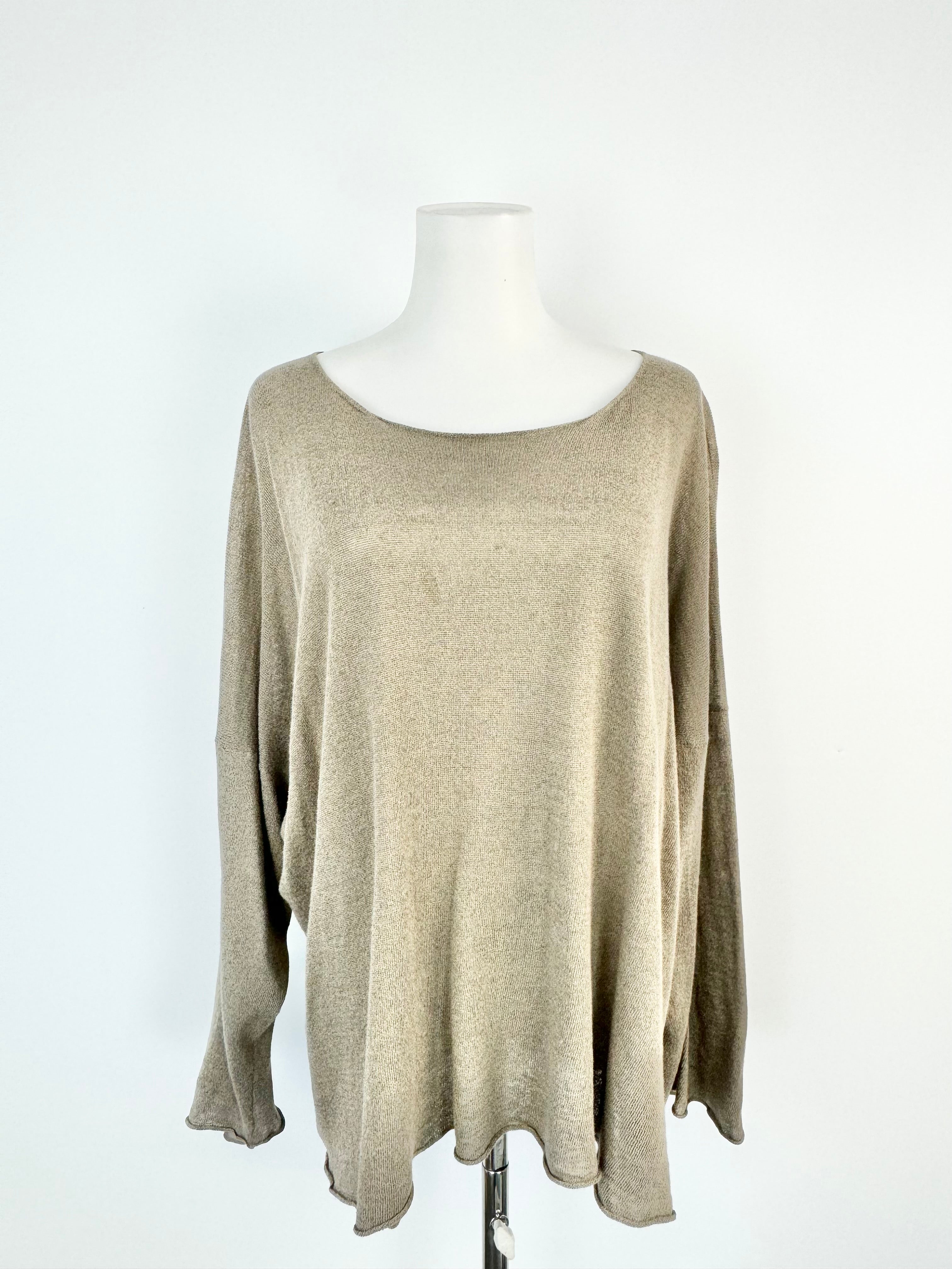 Beige sweater on a mannequin against a white background
