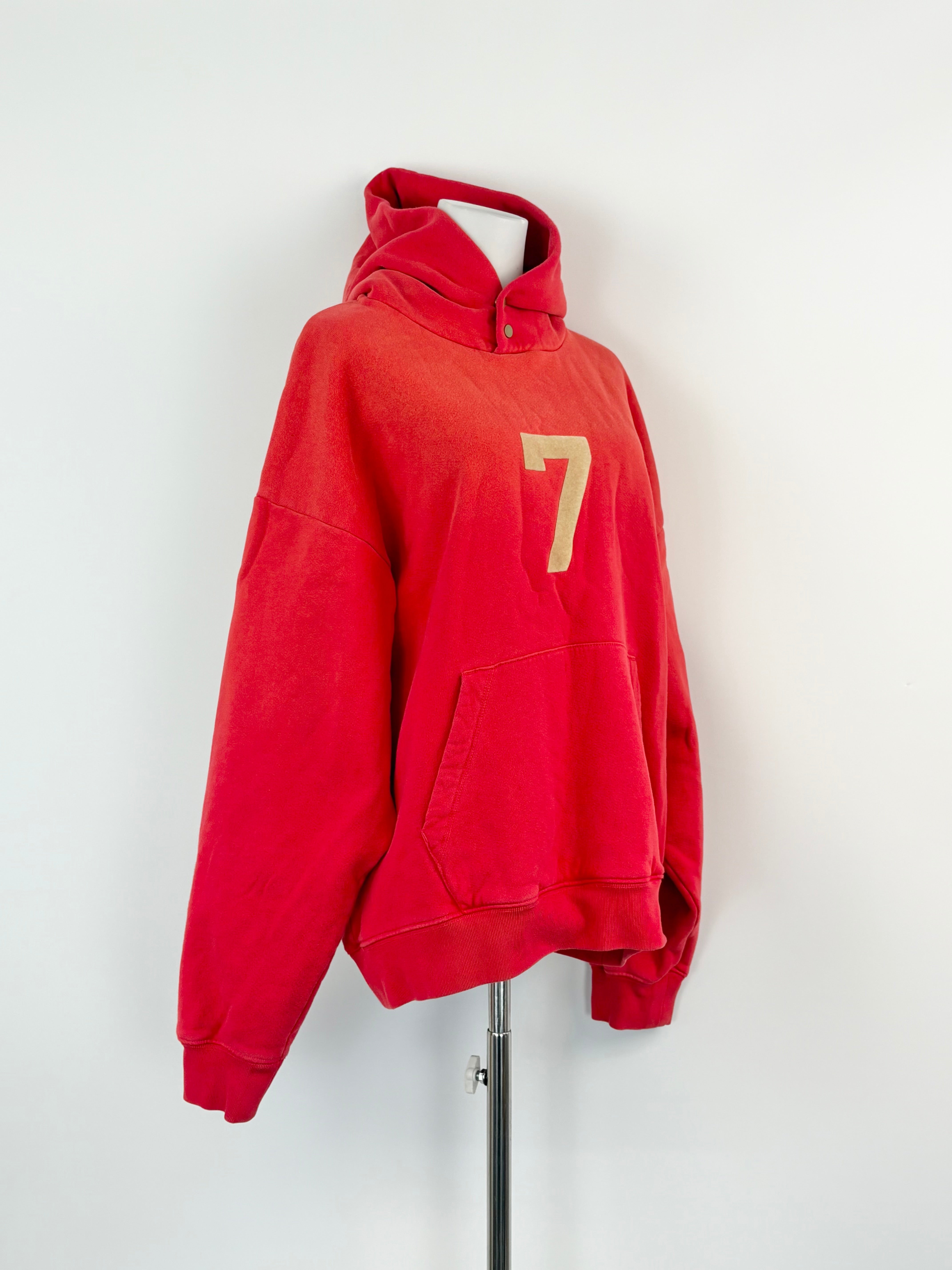Red hoodie with a gold number 7 on a white background