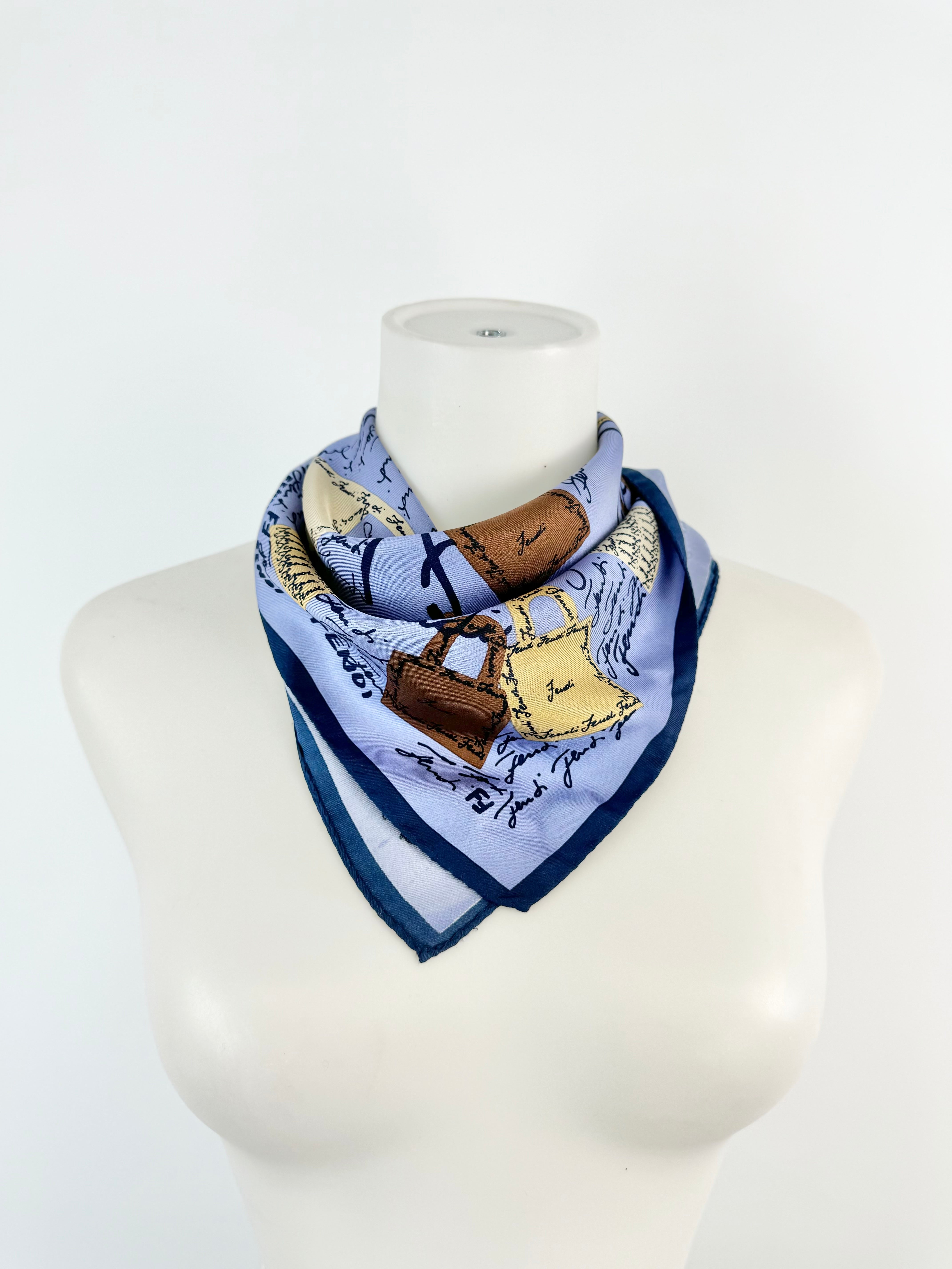 Scarf with a horse and bag design on a mannequin against a white background