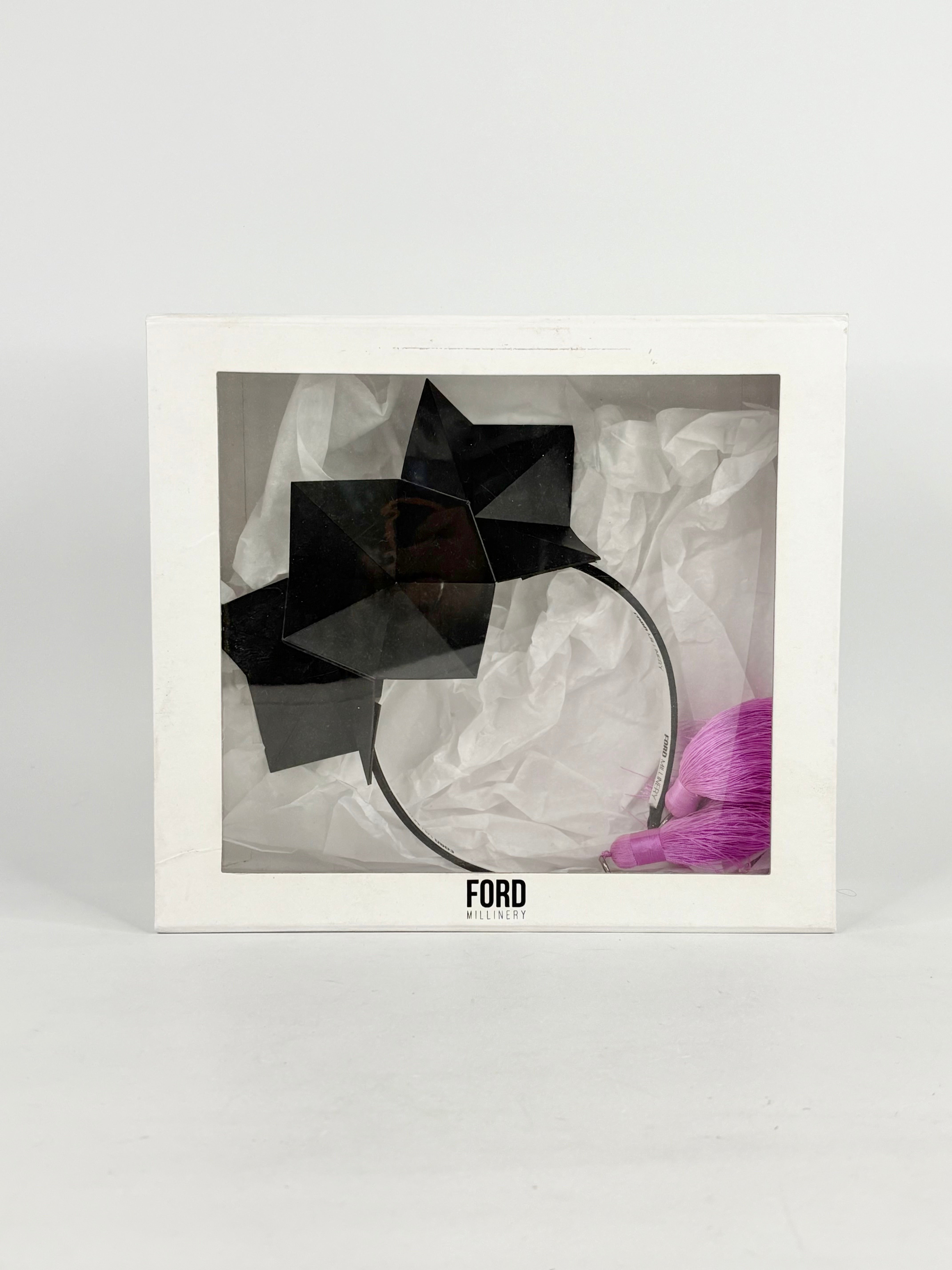 Framed artwork with a black abstract sculpture on a white background, featuring the brand 'FORD'.