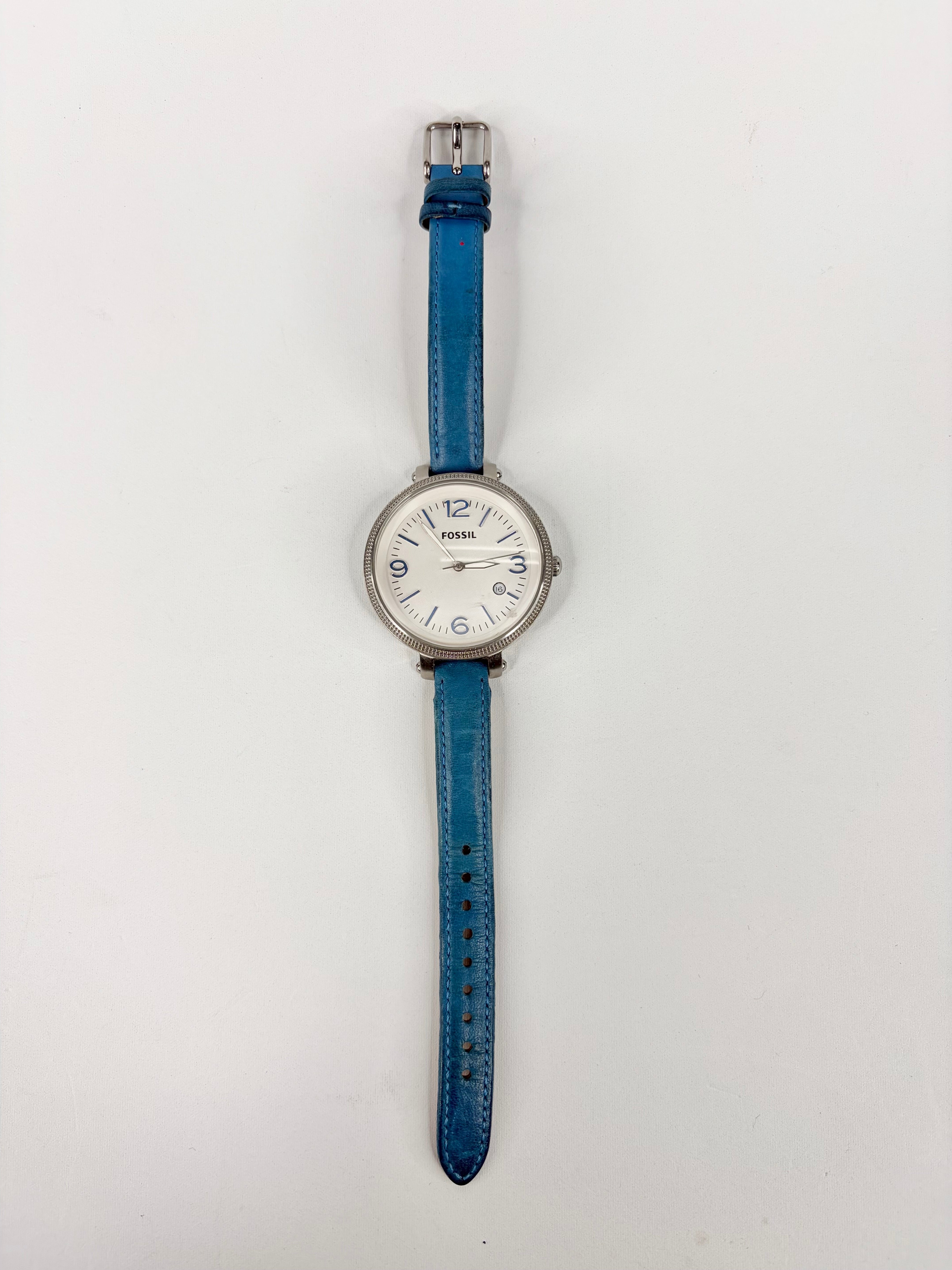 Wristwatch with a blue strap on a white background