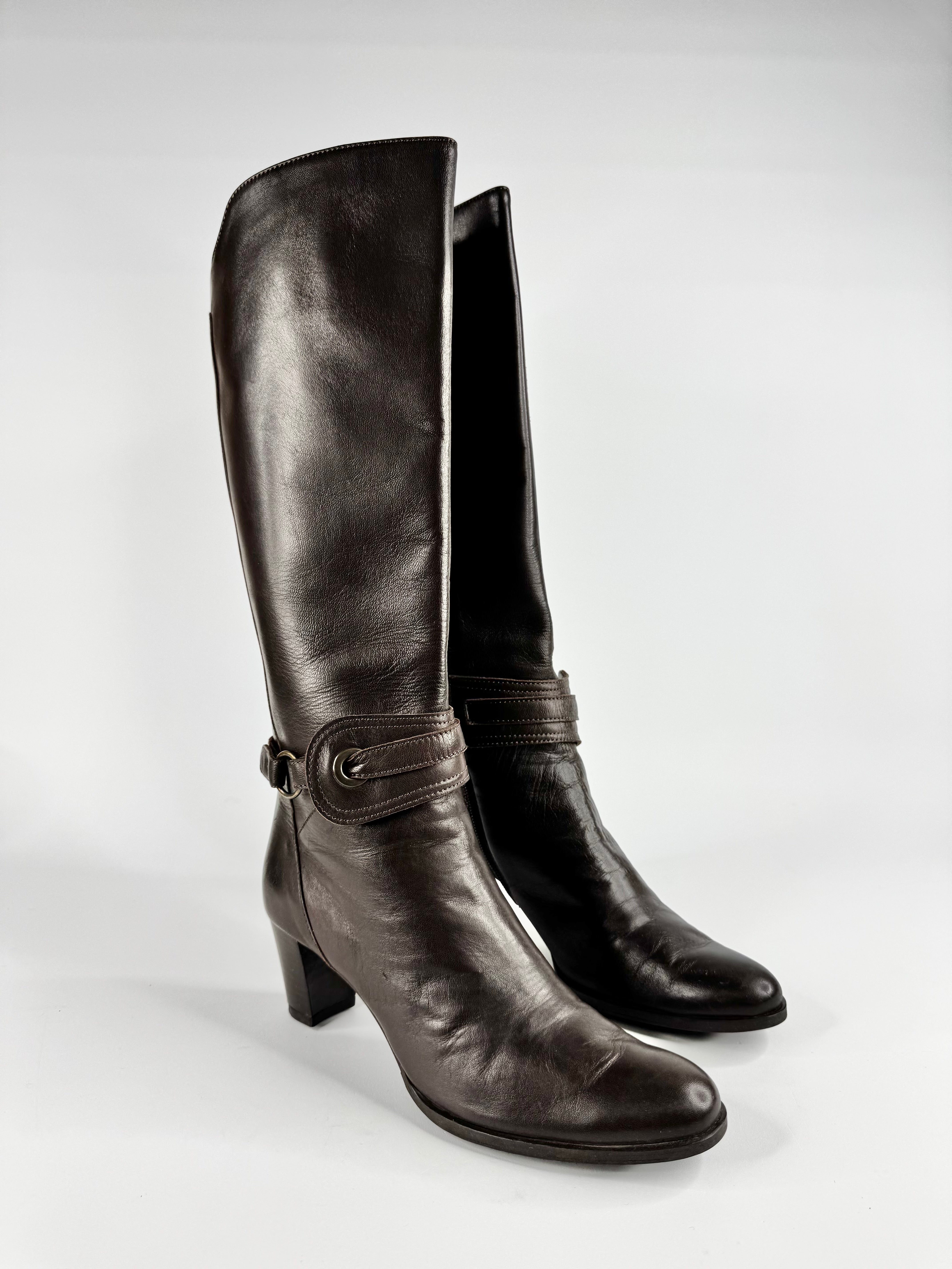 Pair of brown leather knee-high boots on a white background