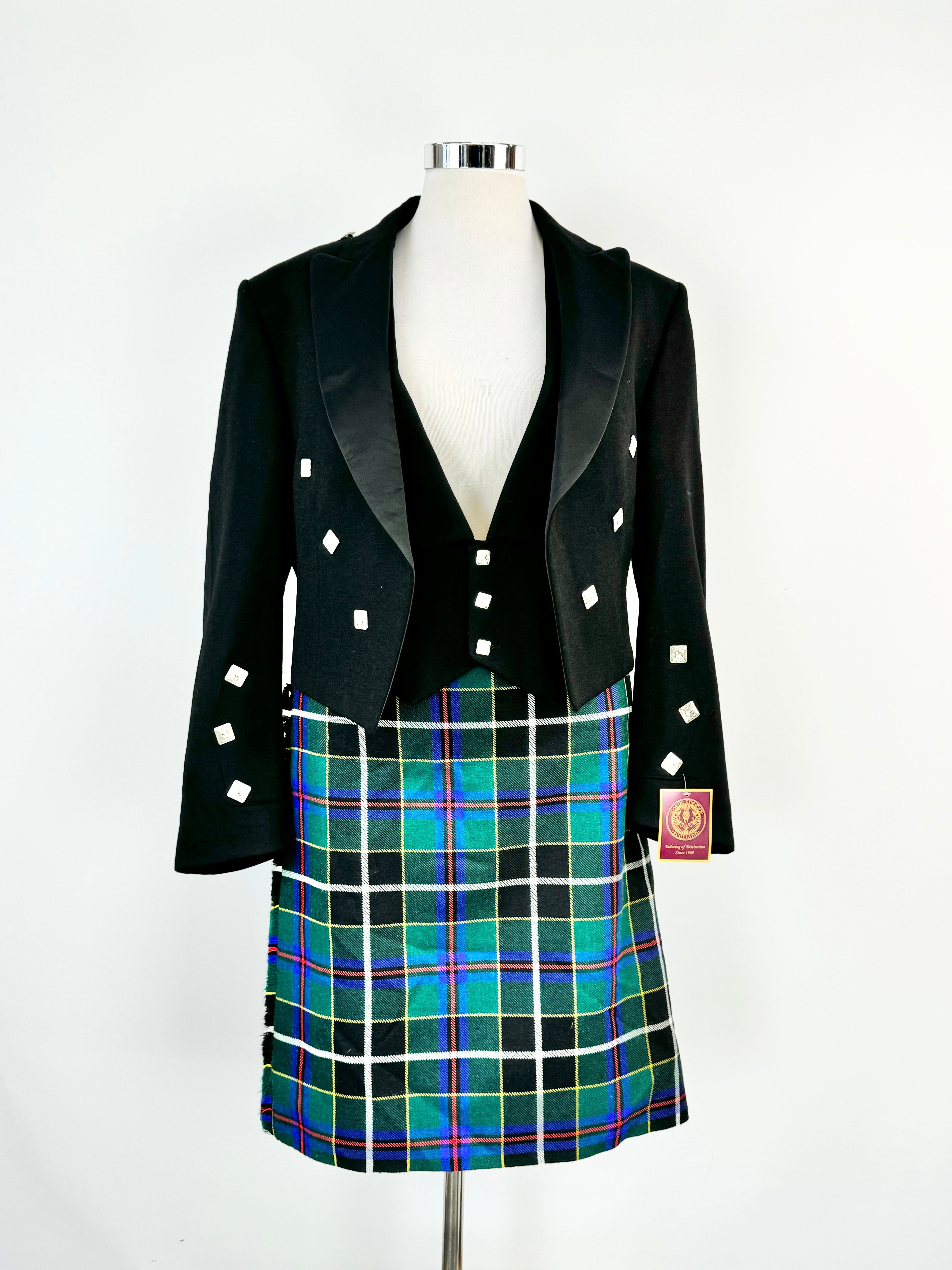 A three piece black Prince Charlie suit and kilt set, with the jacket and waistcoat featuring small diamond-shaped buttons and the kilt in a colorful tartan pattern.