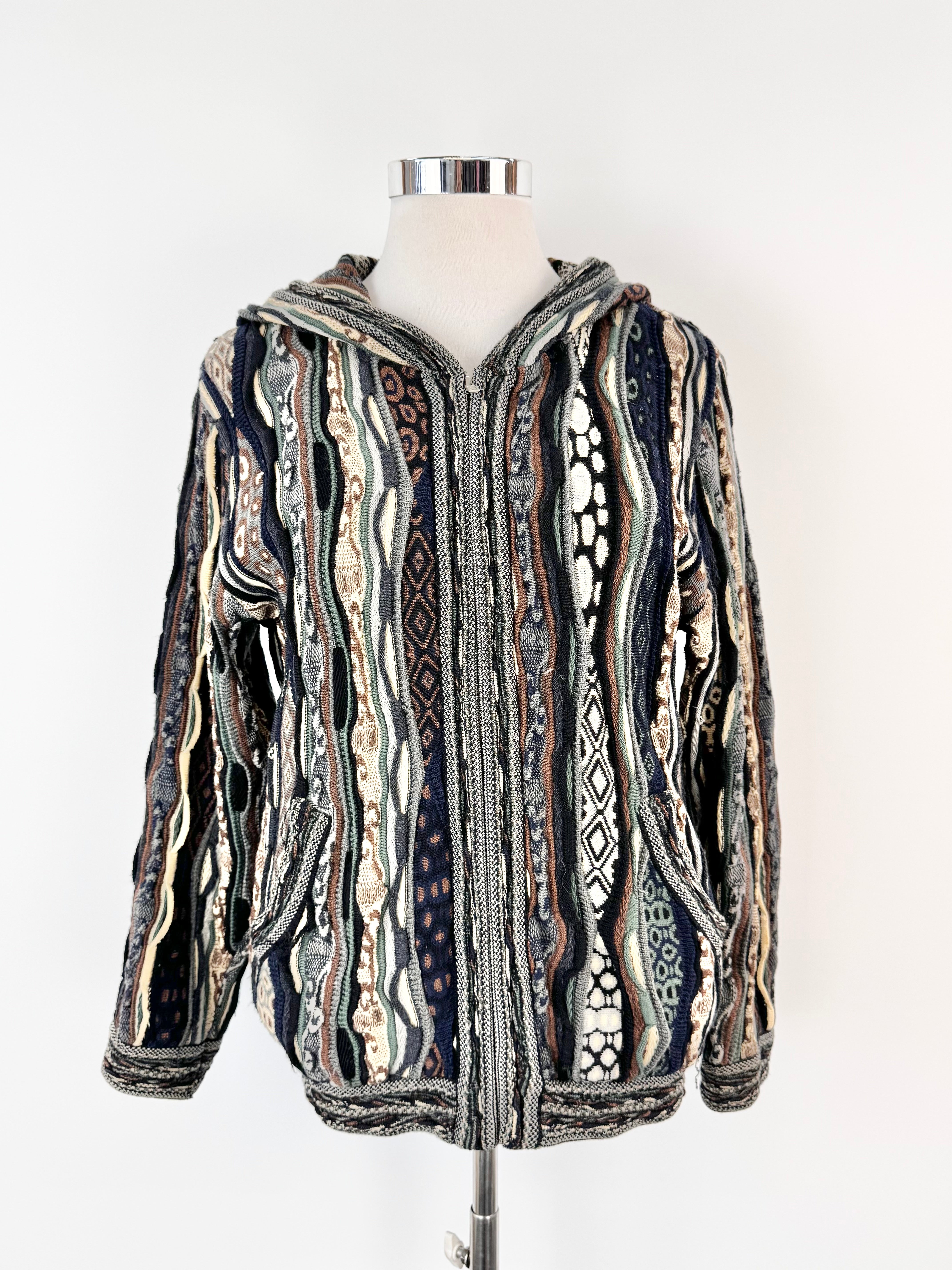 Patterned hoodie on a mannequin against a white background