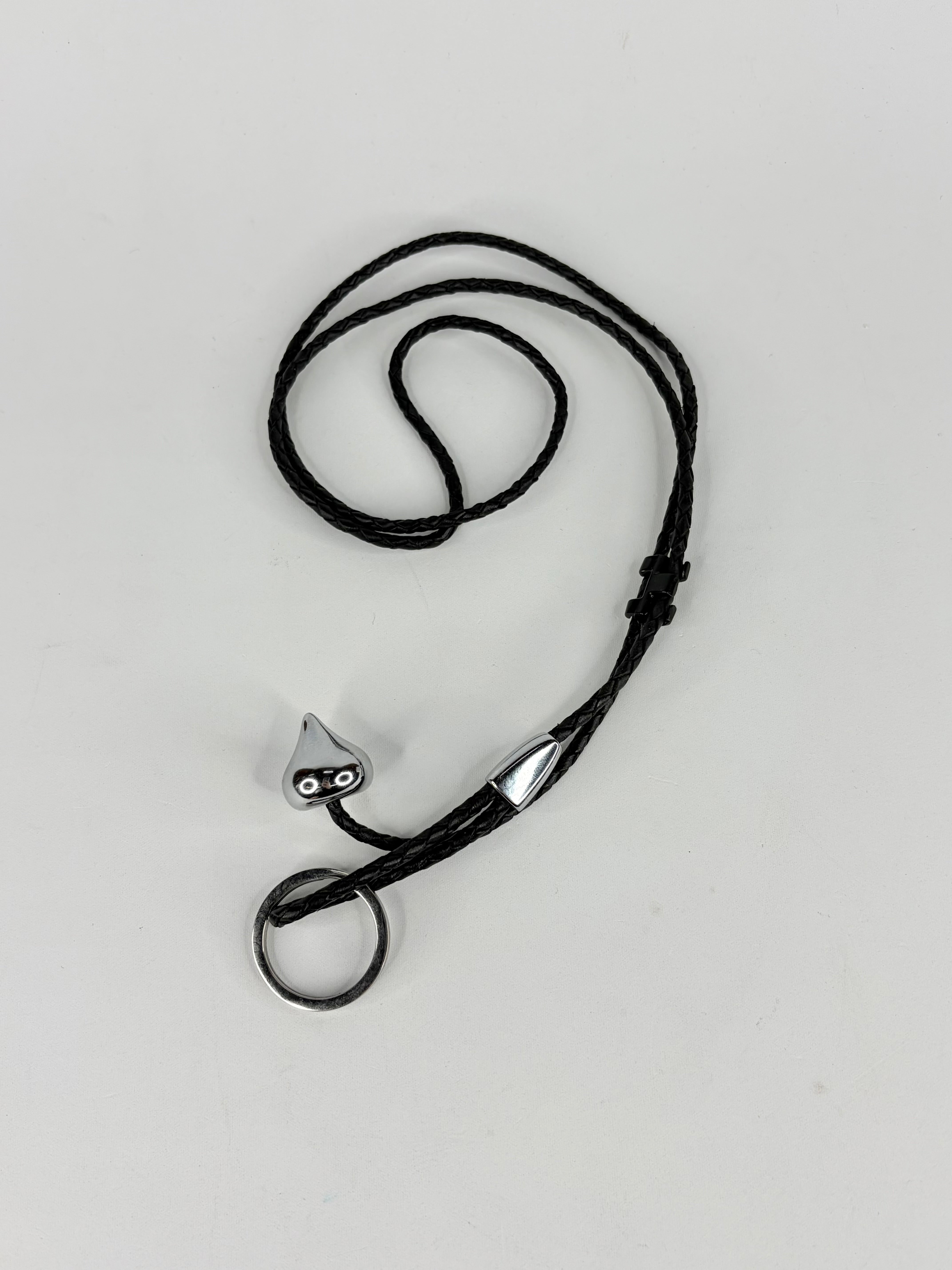 Black leather lanyard with metal clip on a white background