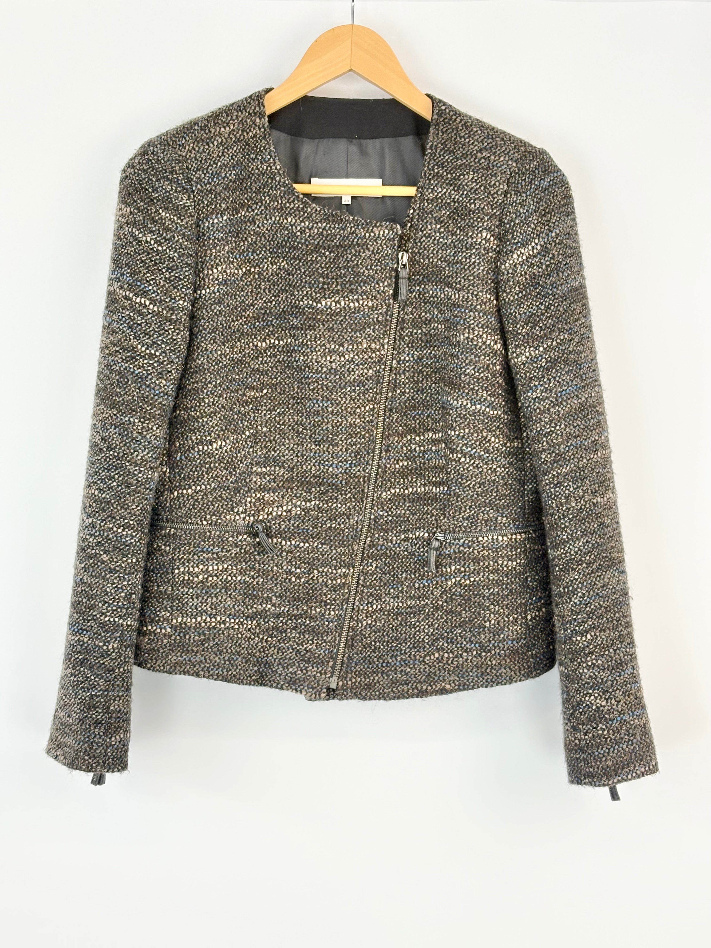 Textured jacket on a hanger against a white background