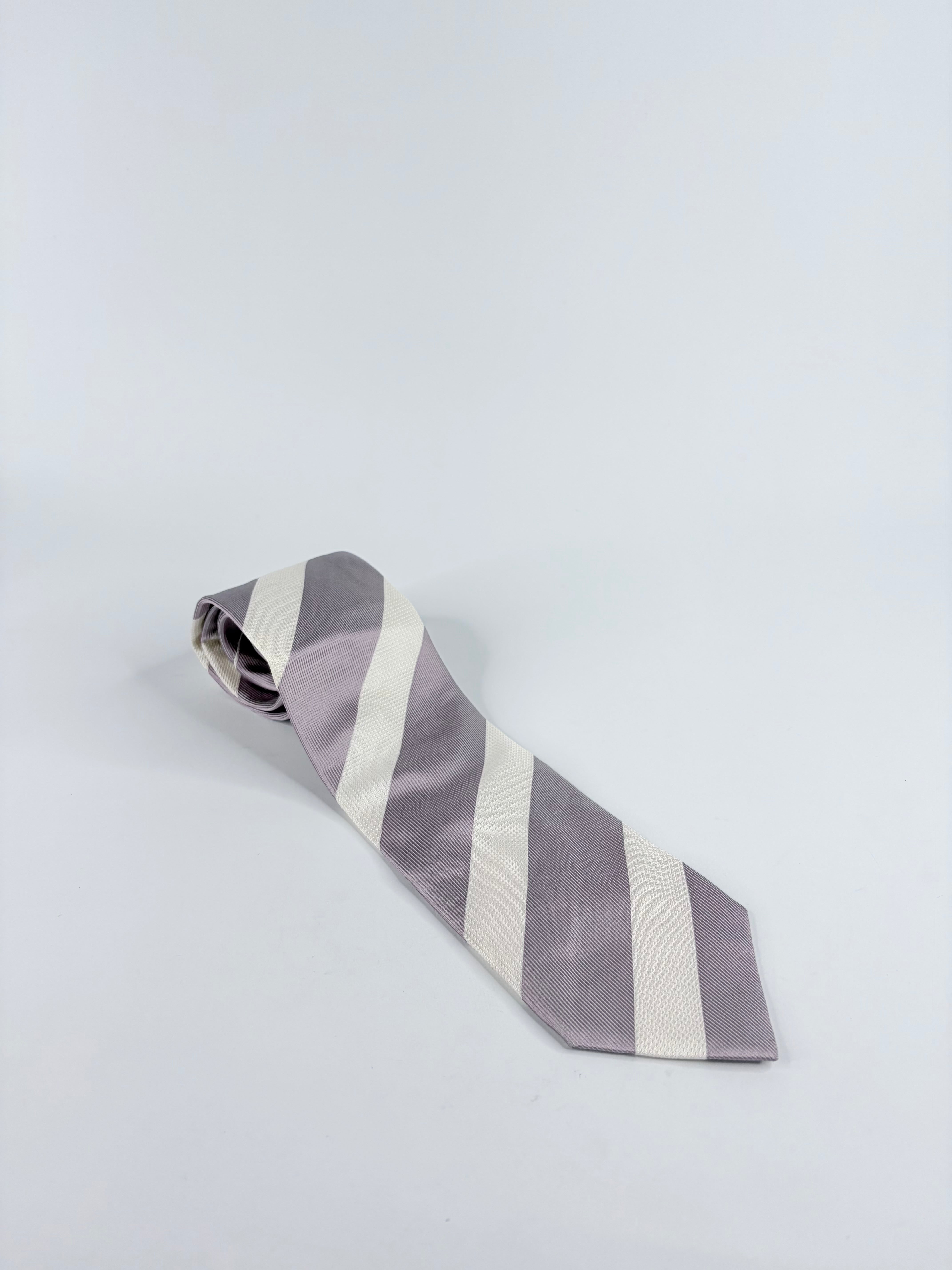 Striped tie on a light gray background