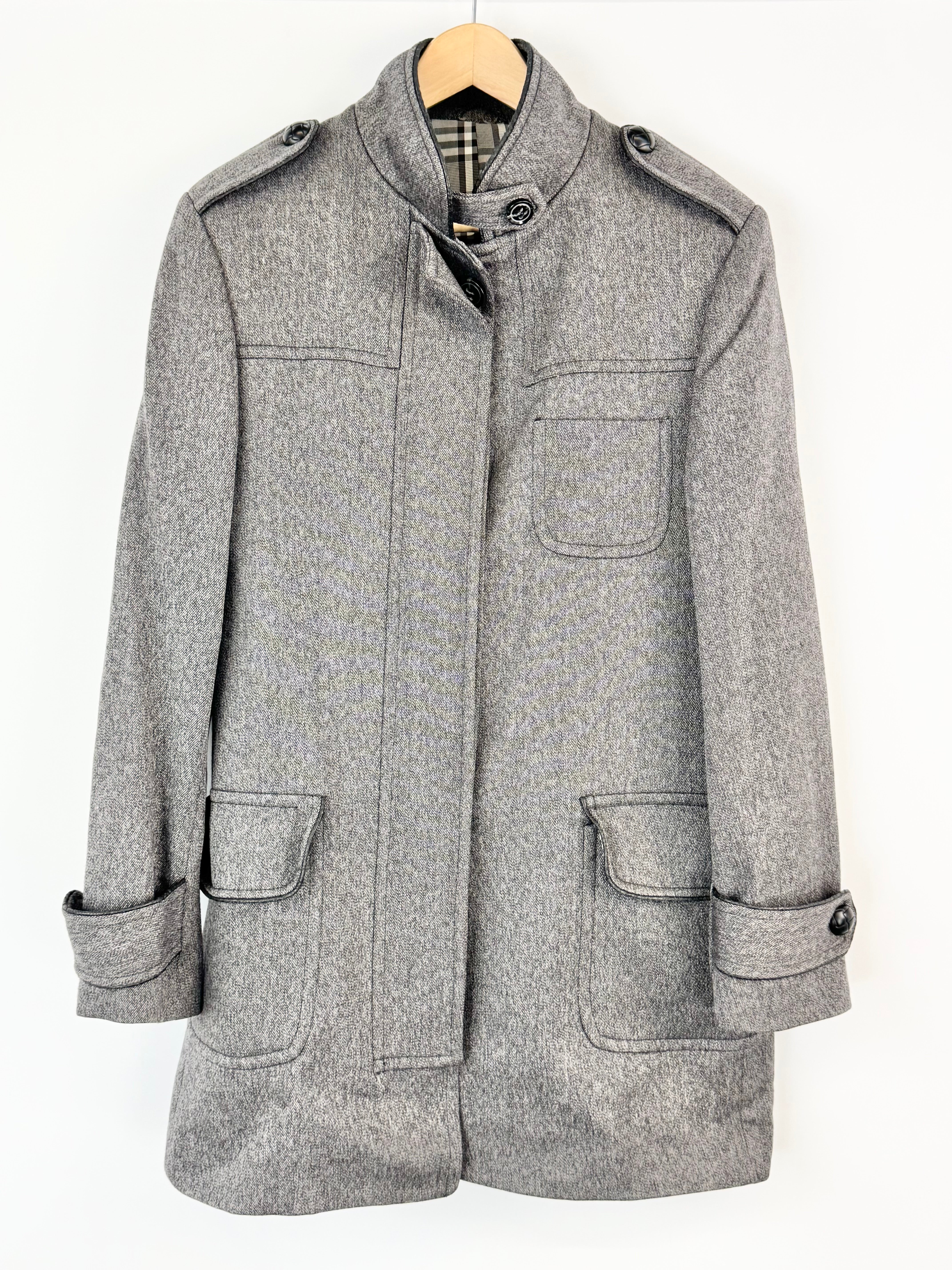 Gray coat on a hanger against a white background