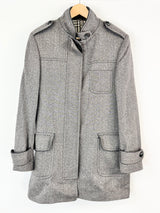 Gray coat on a hanger against a white background