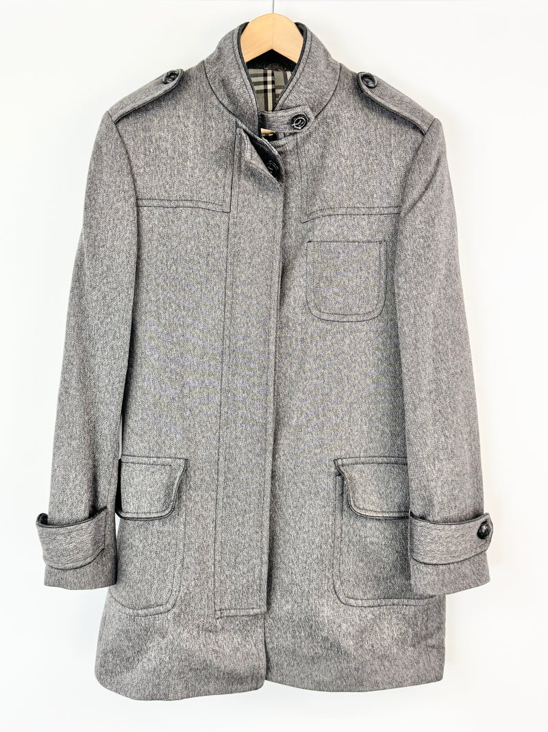 Gray coat on a hanger against a white background