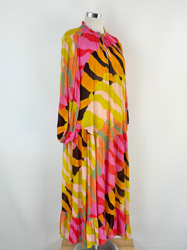 Colorful patterned dress on a mannequin against a white background