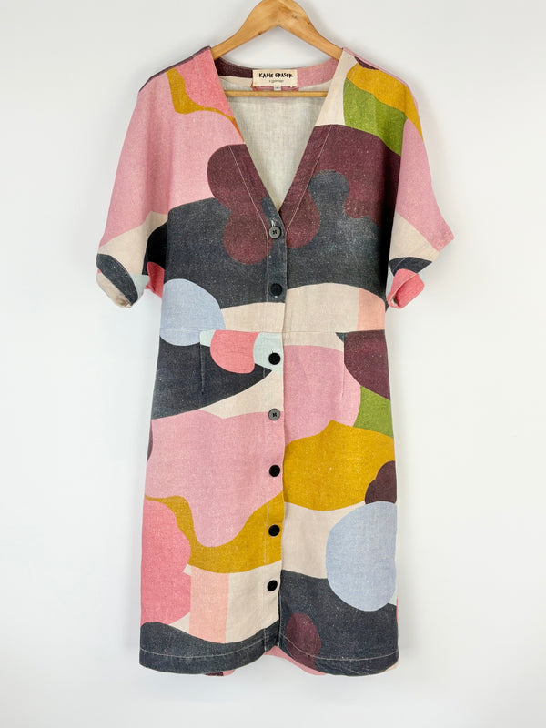 Colorful Gorman patterned shirt on a hanger against a white background