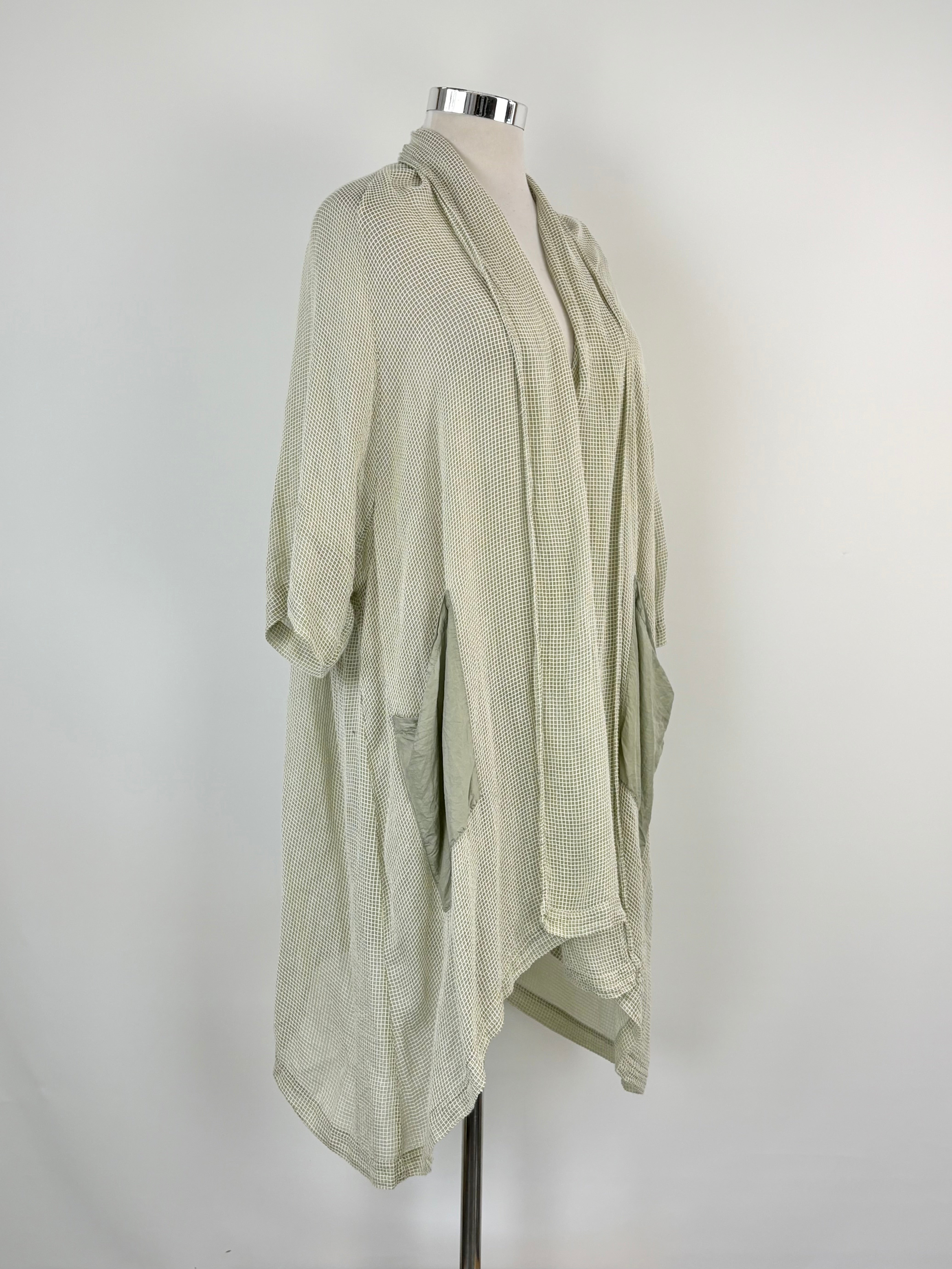 A sheer cardigan with sage and white stripes, displayed on a mannequin against a white background.