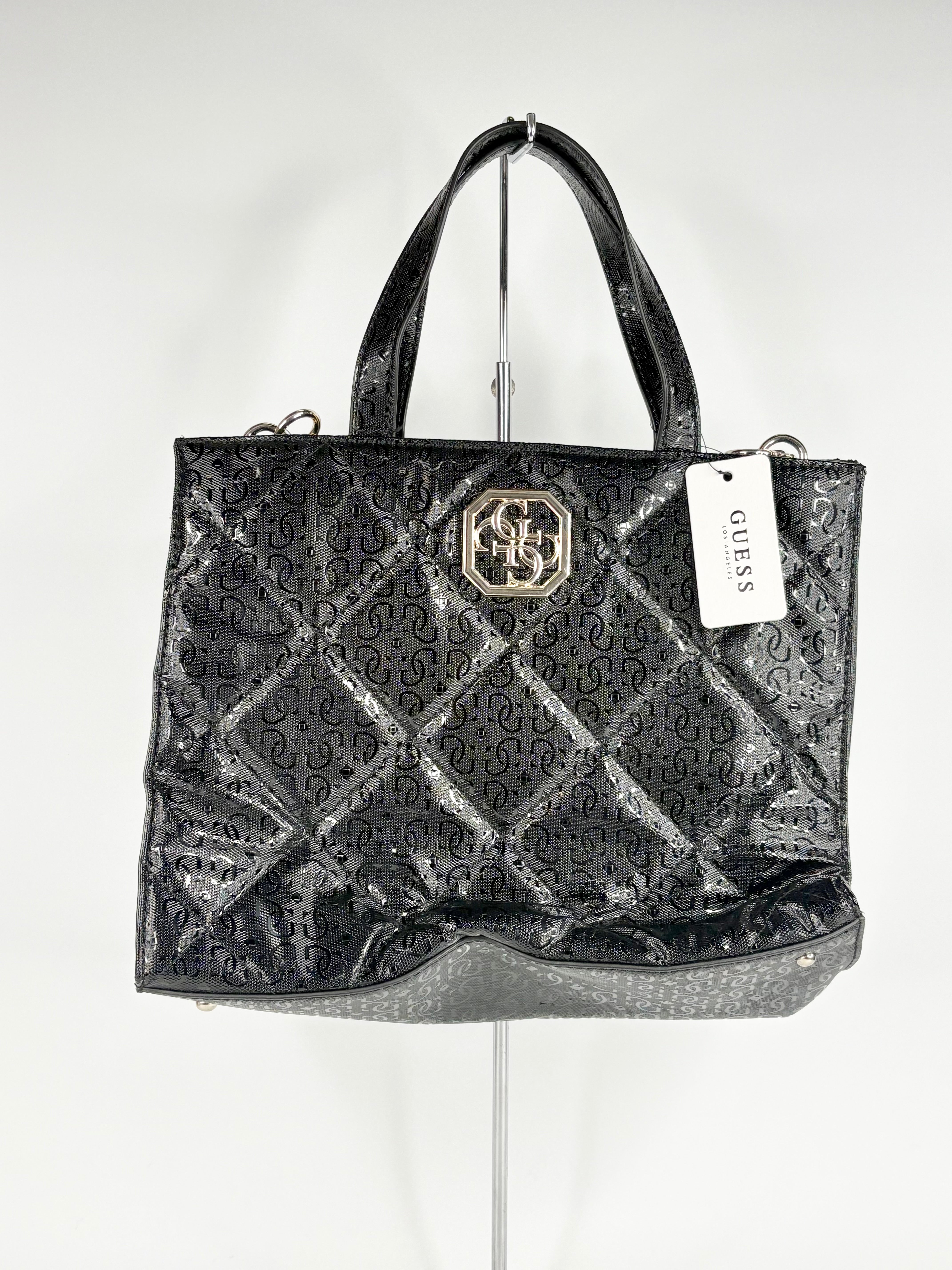 Black patterned handbag with a brand tag on a white background