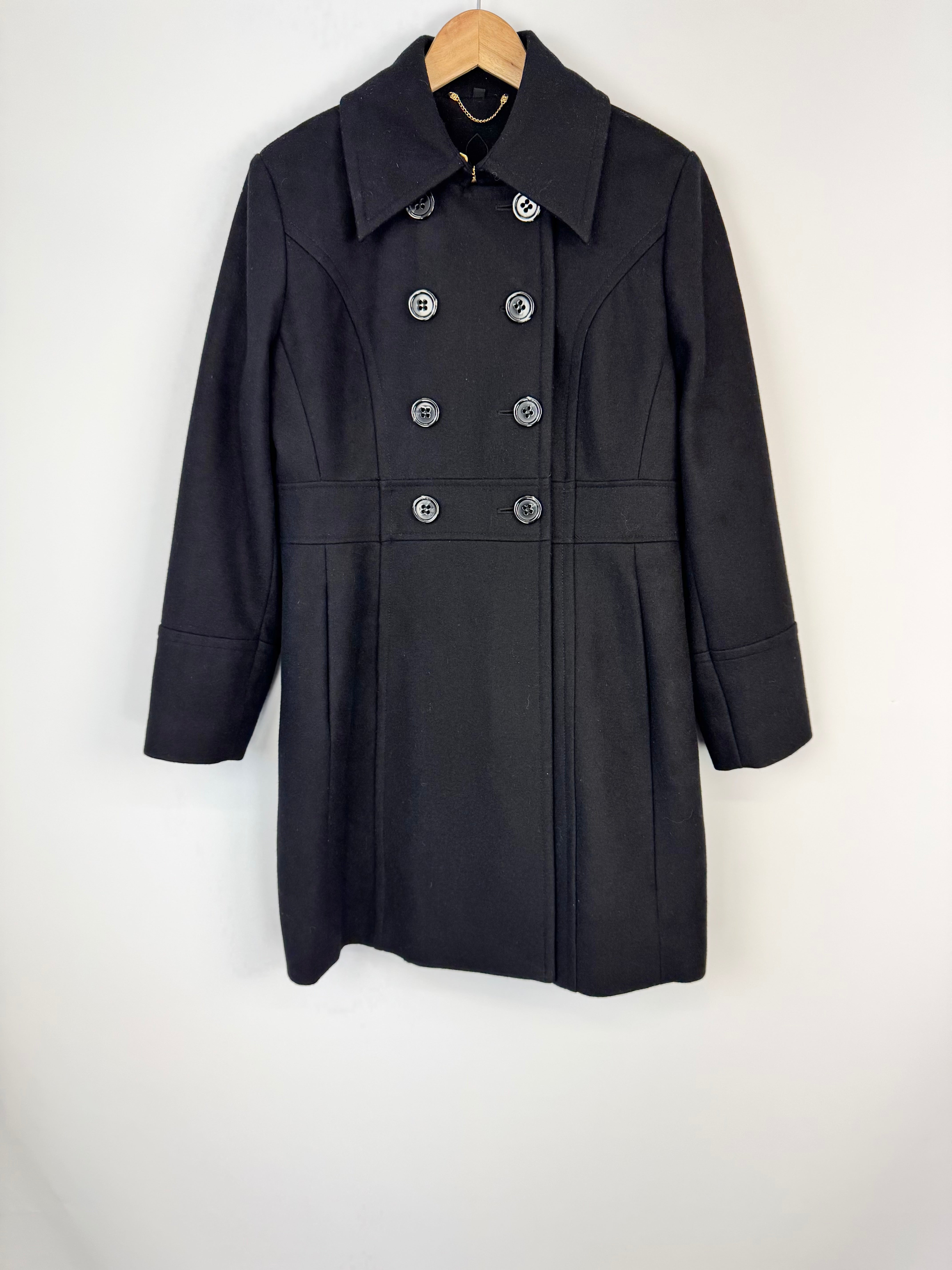 Black coat on a hanger against a white background