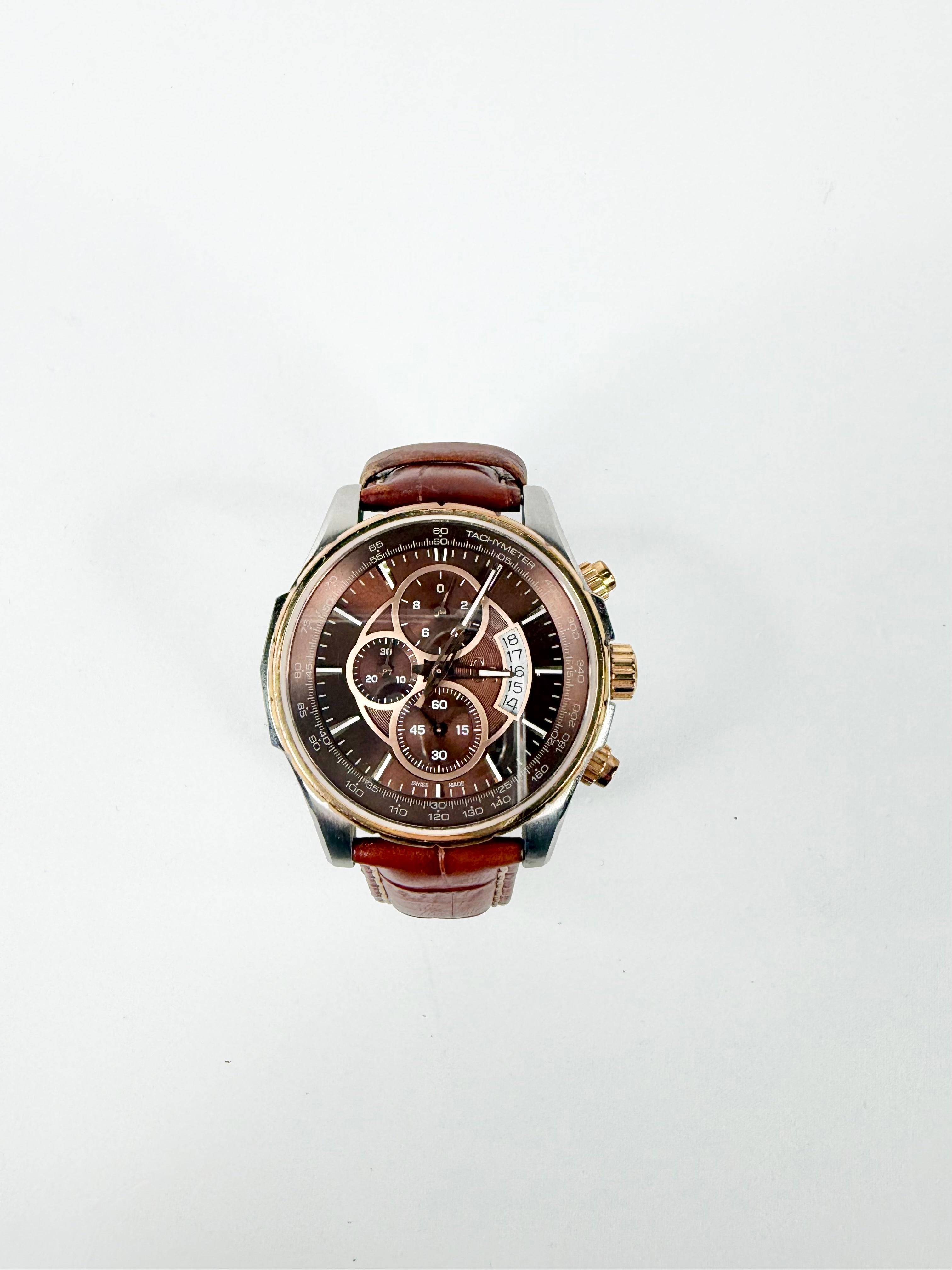 Wristwatch with brown leather strap and brown dial on a white background