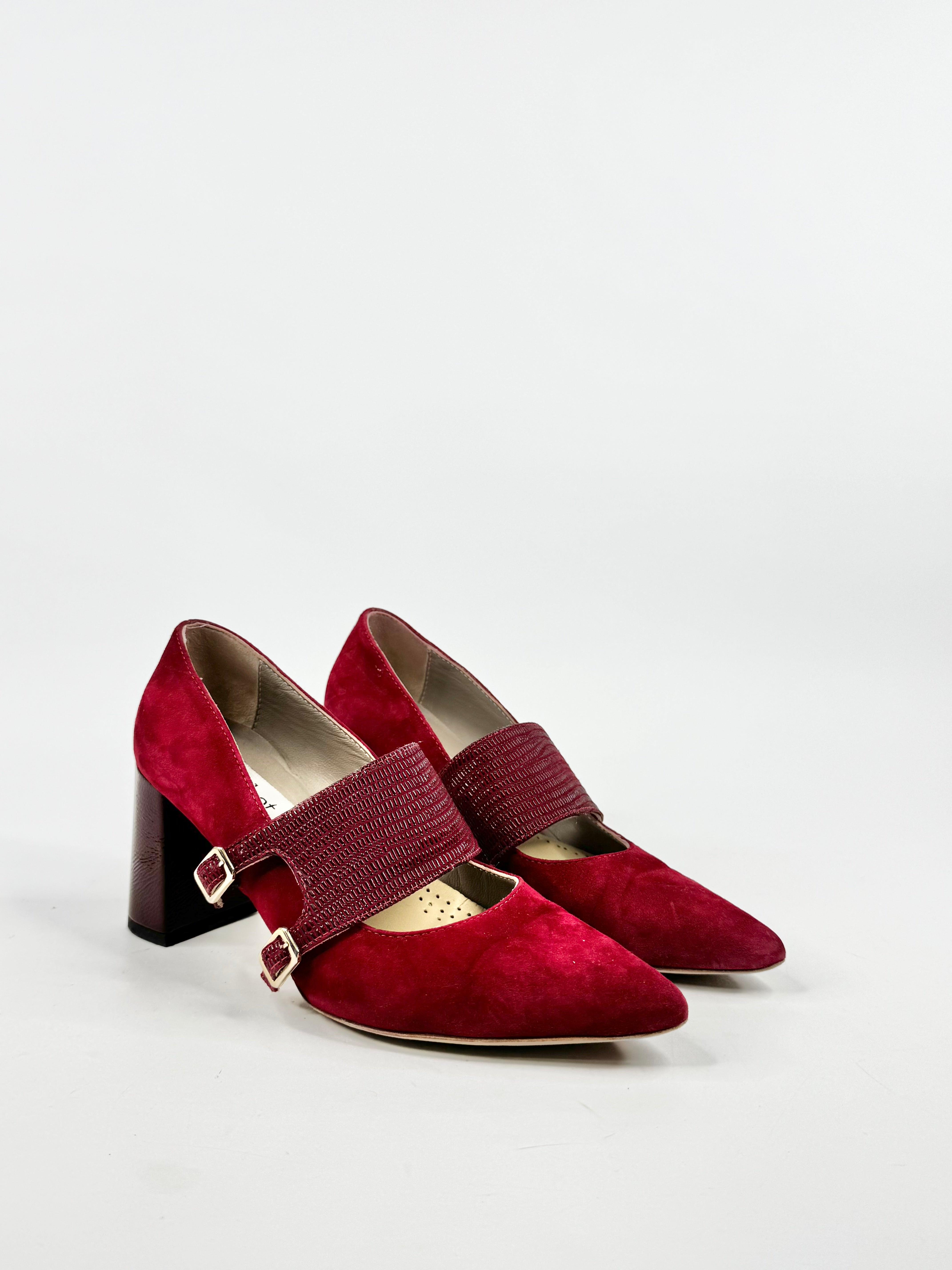 Red high-heeled shoes with a strap on a light gray background