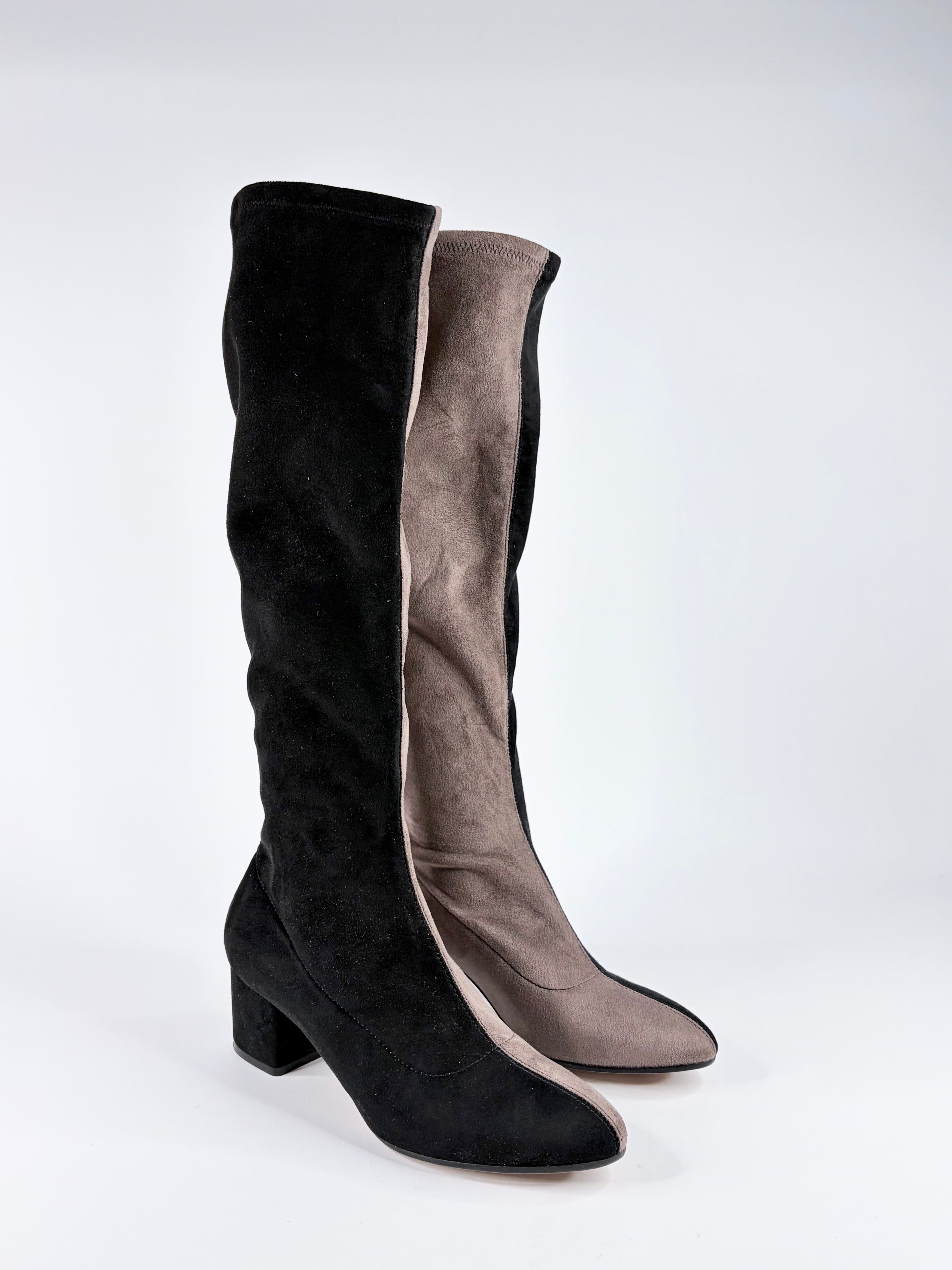 Black and gray knee-high boots on a white background