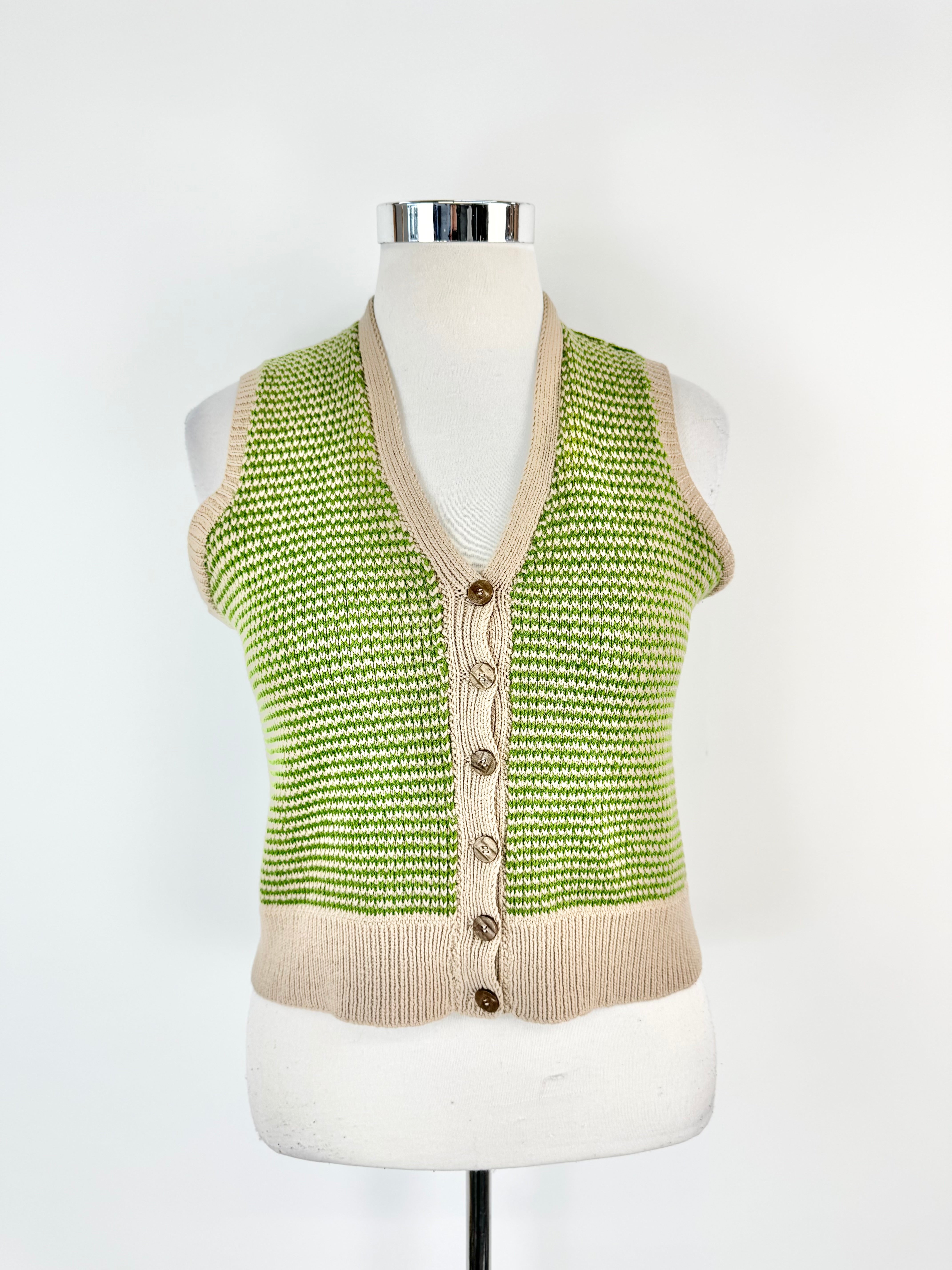 Green and beige knitted vest on a mannequin against a white background