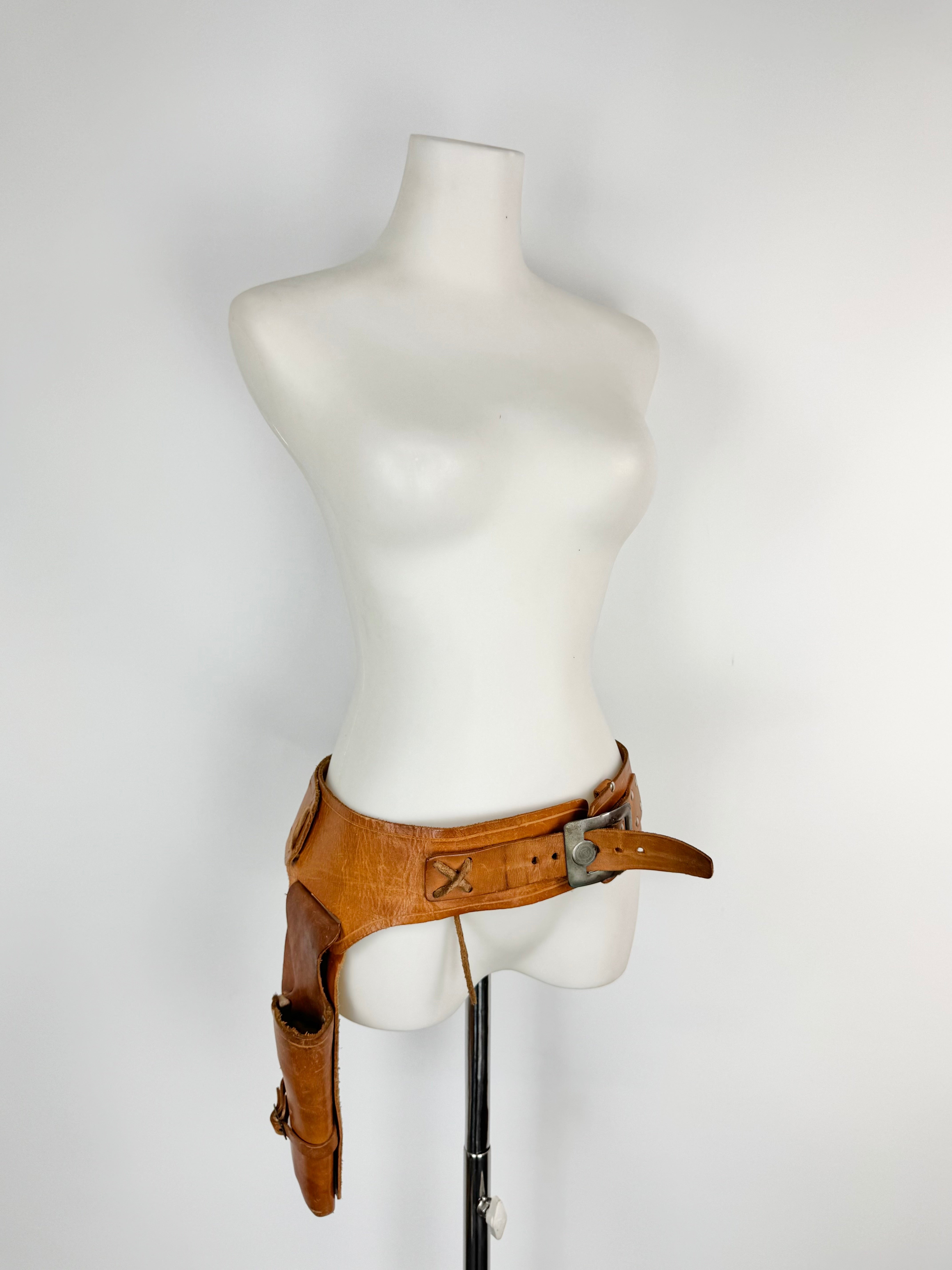 Mannequin wearing a brown leather belt on a white background