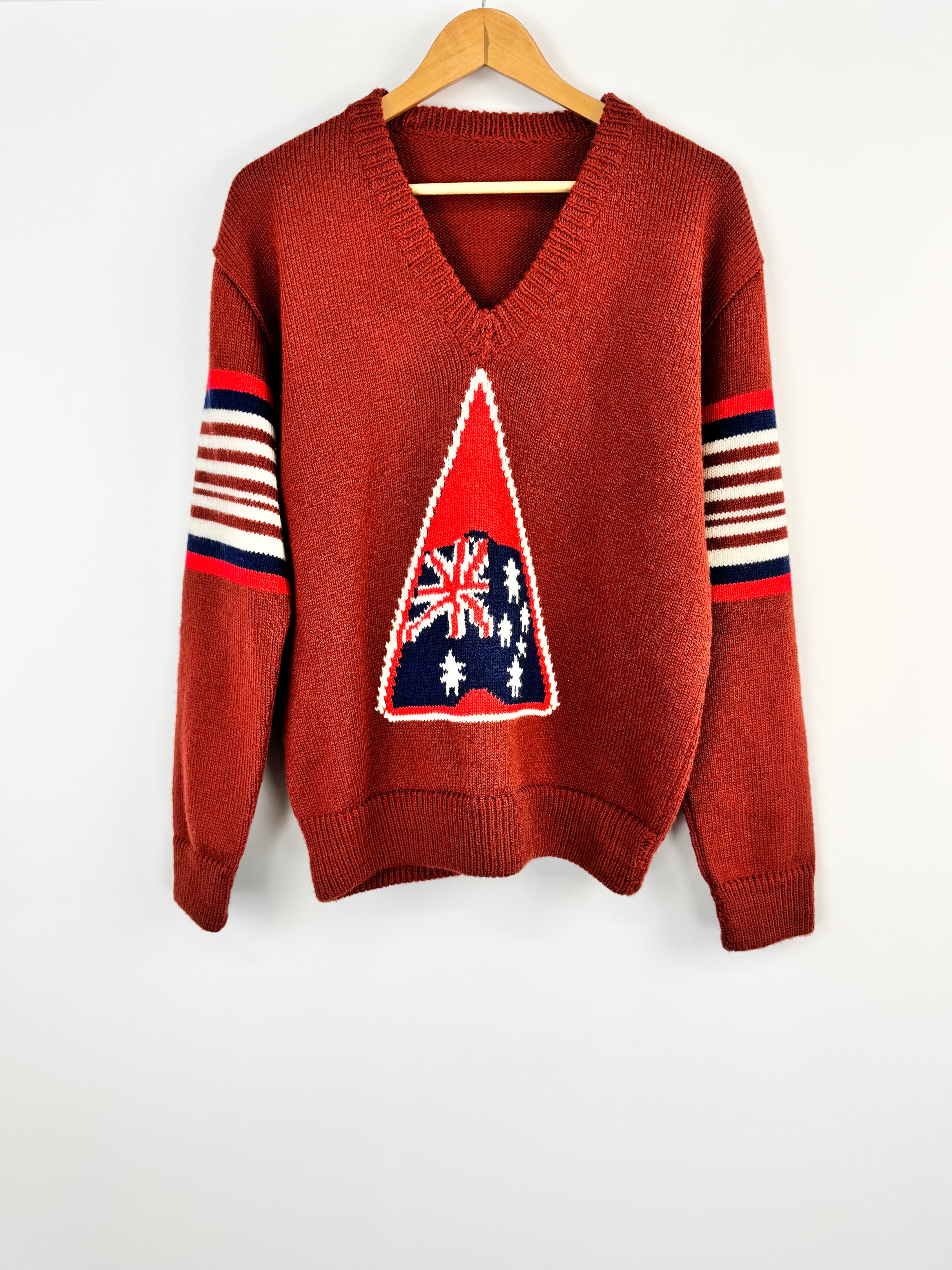 Brown sweater with a geometric design on a white background