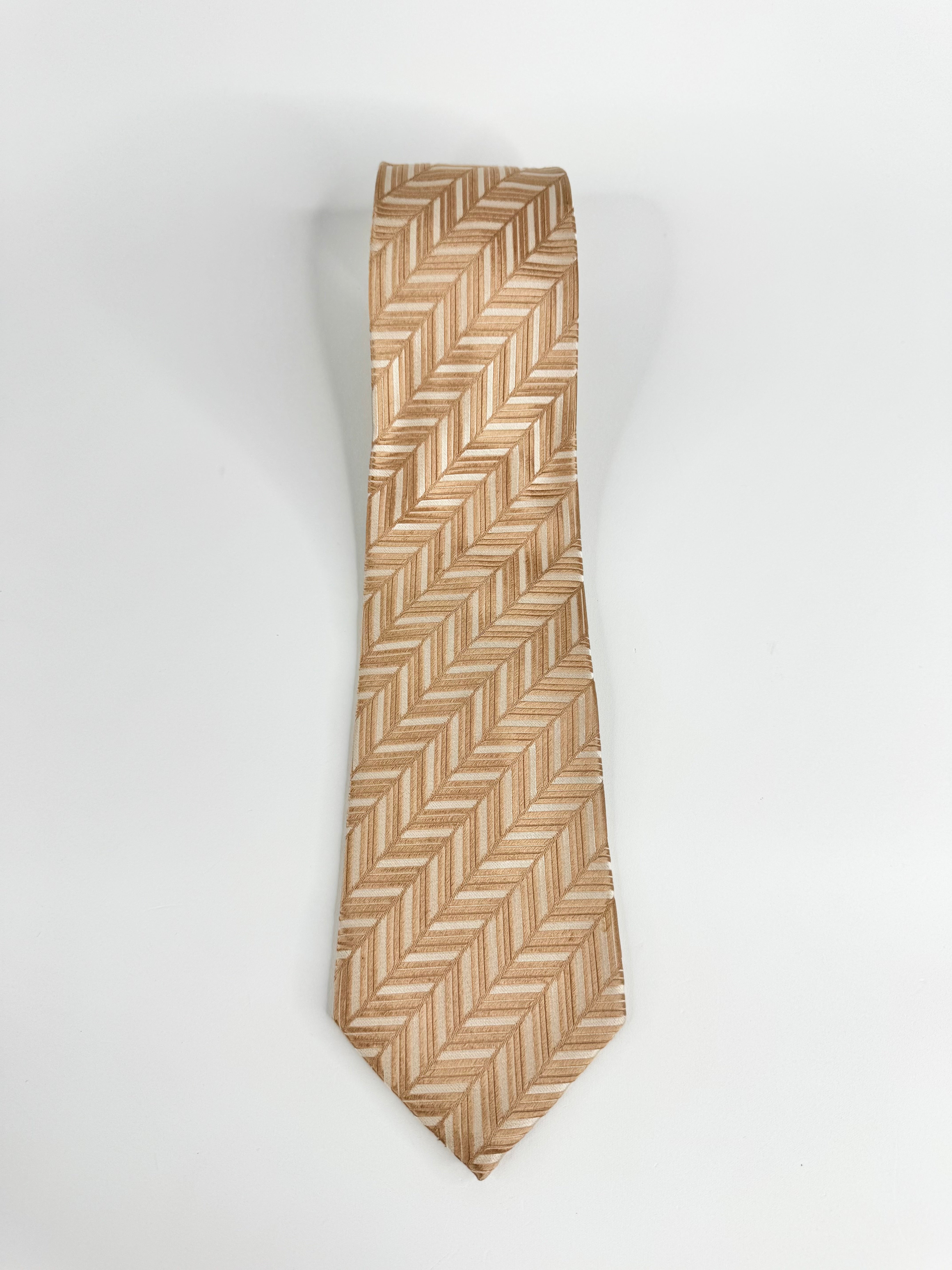 Beige patterned tie on a white background