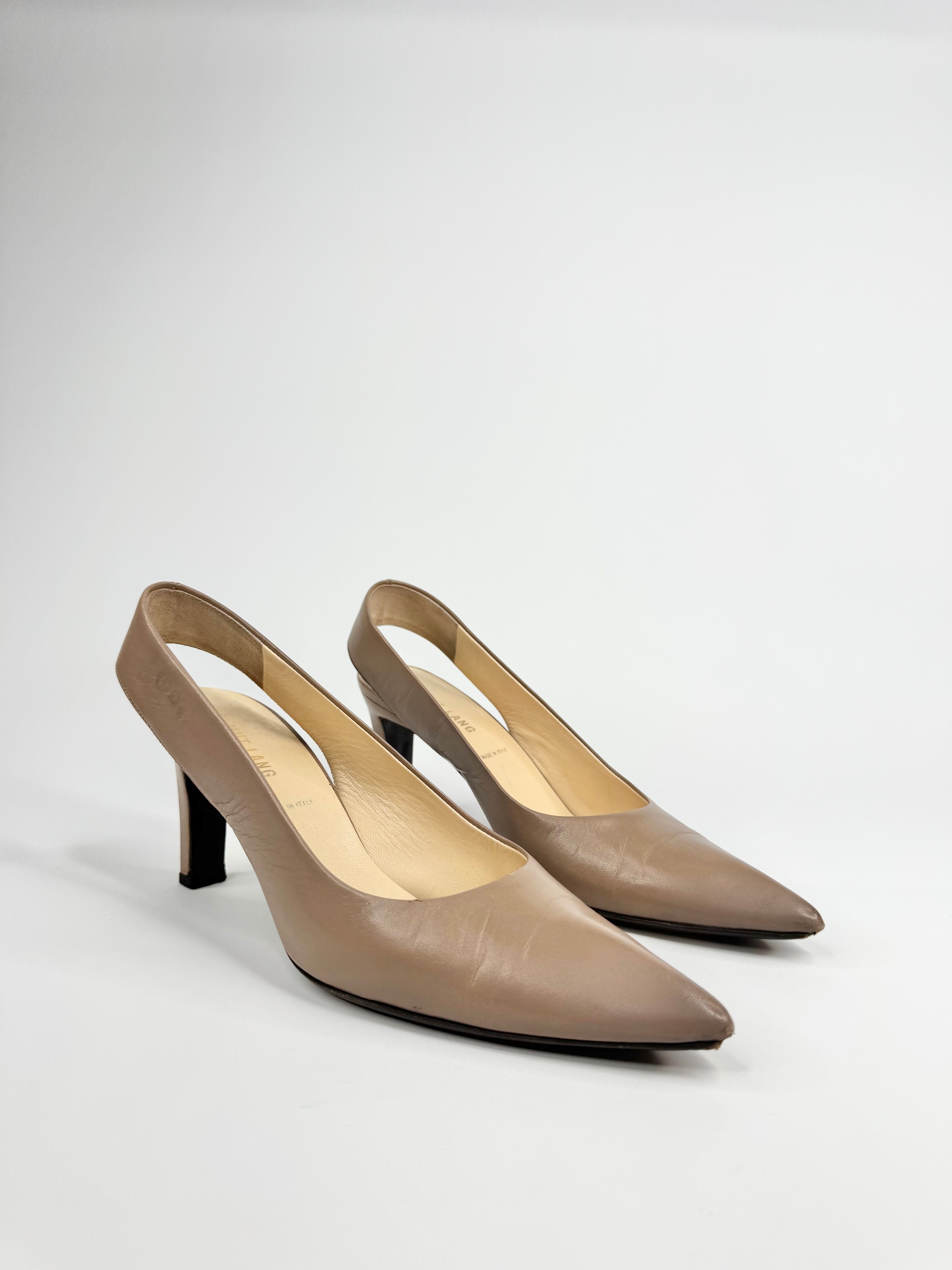 Pair of beige high-heeled shoes on a light gray background