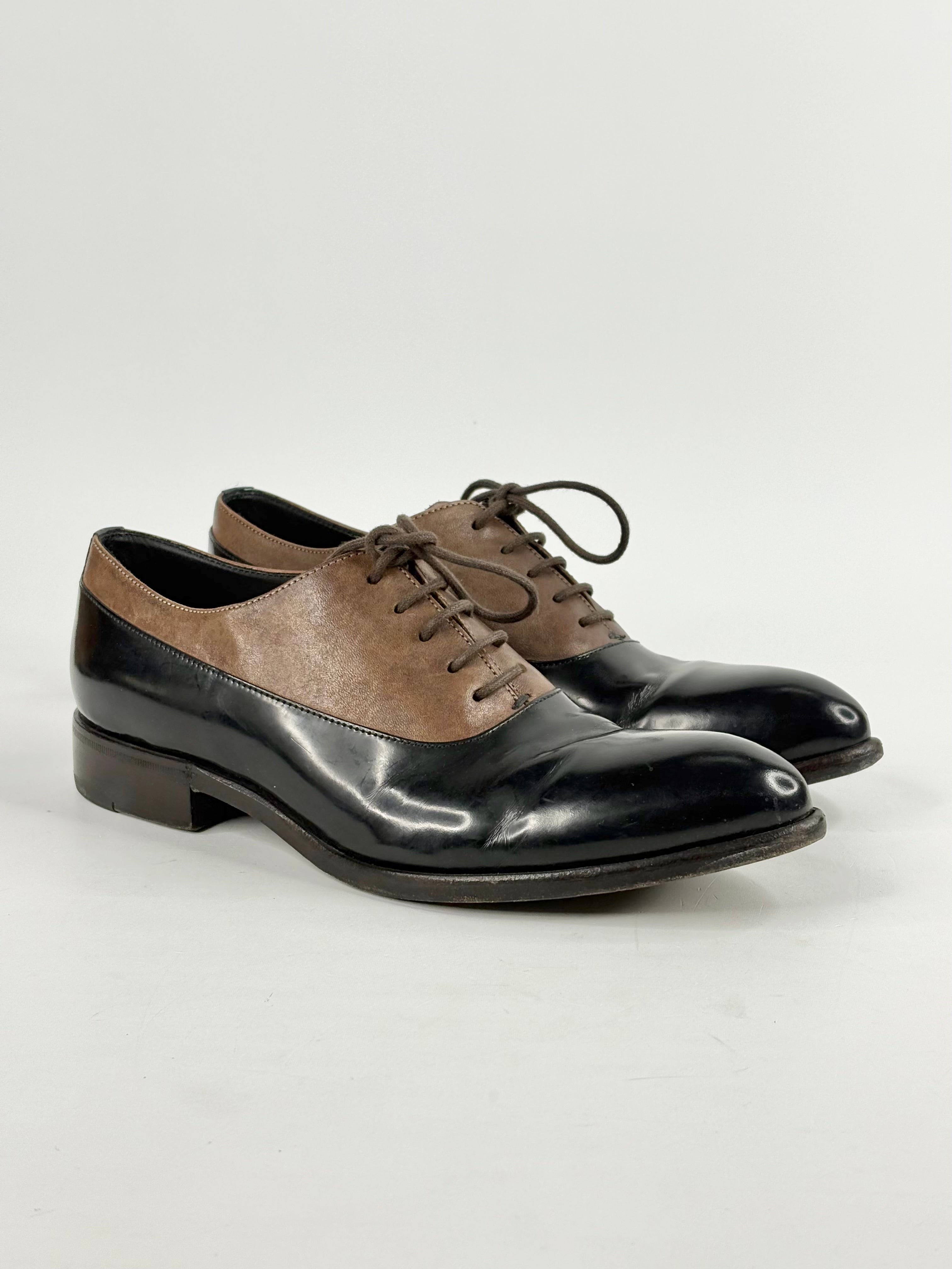 Pair of black and brown dress shoes on a white background