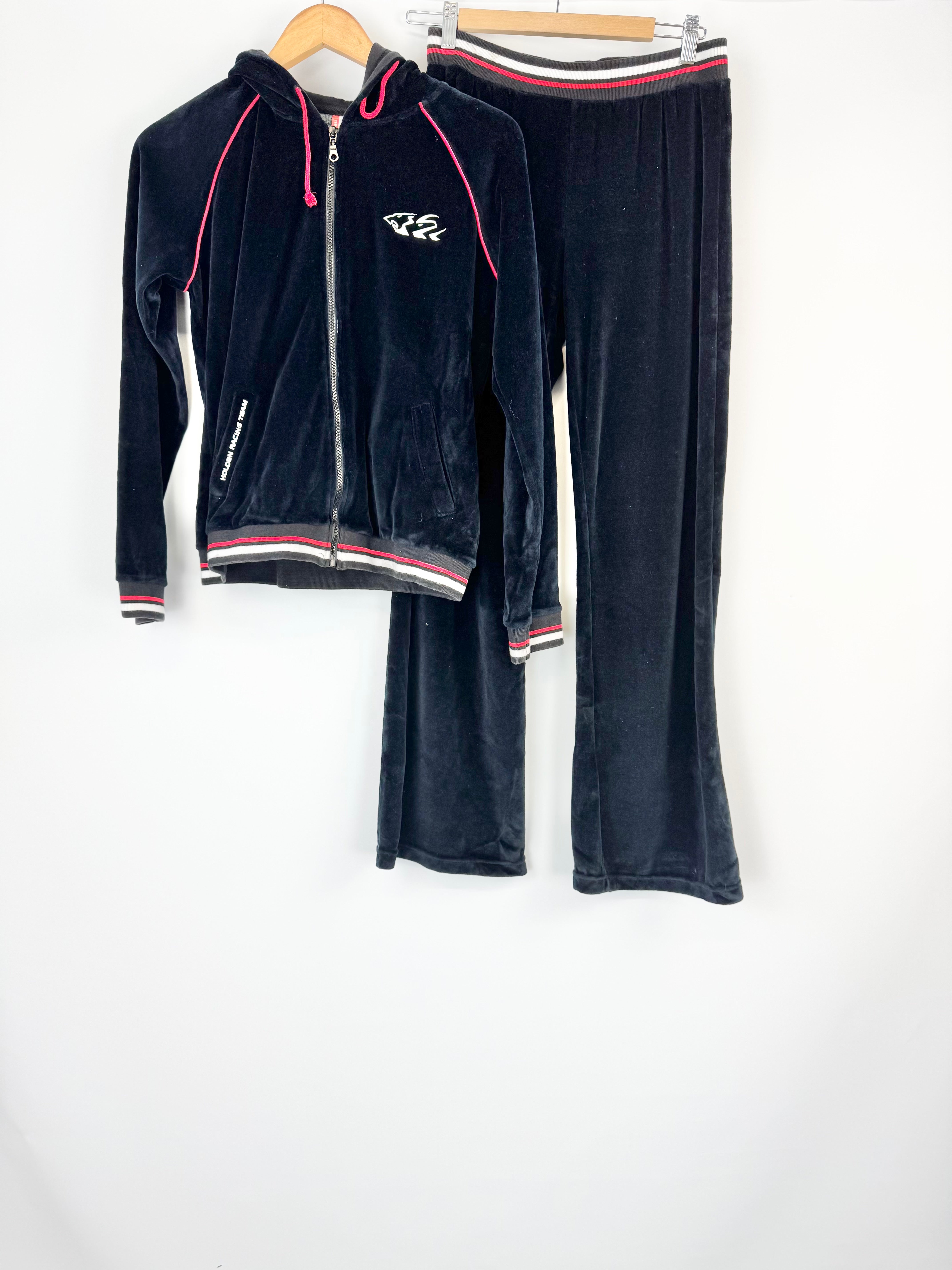 Black tracksuit with red and white accents on a white background