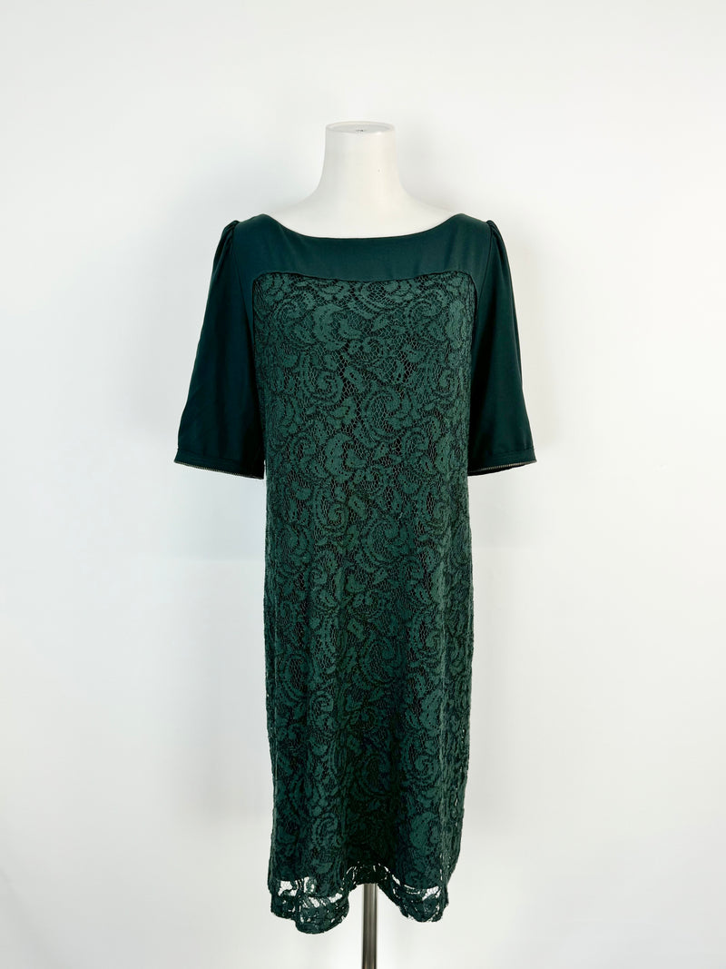 A forest green knee-length dress with half-length sleeves and a lace panel, displayed on a mannequin.