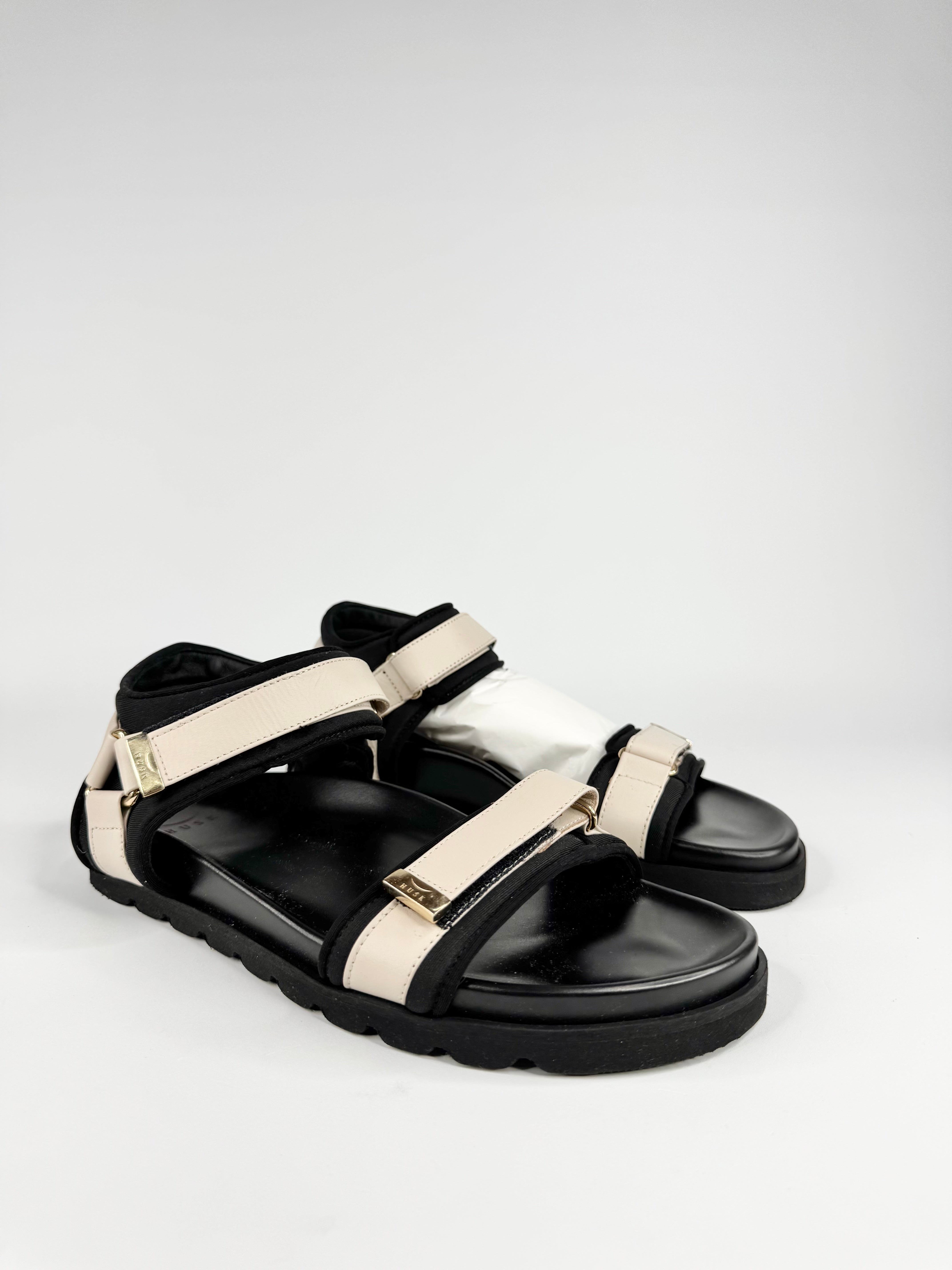 Black and white sandals on a light gray background