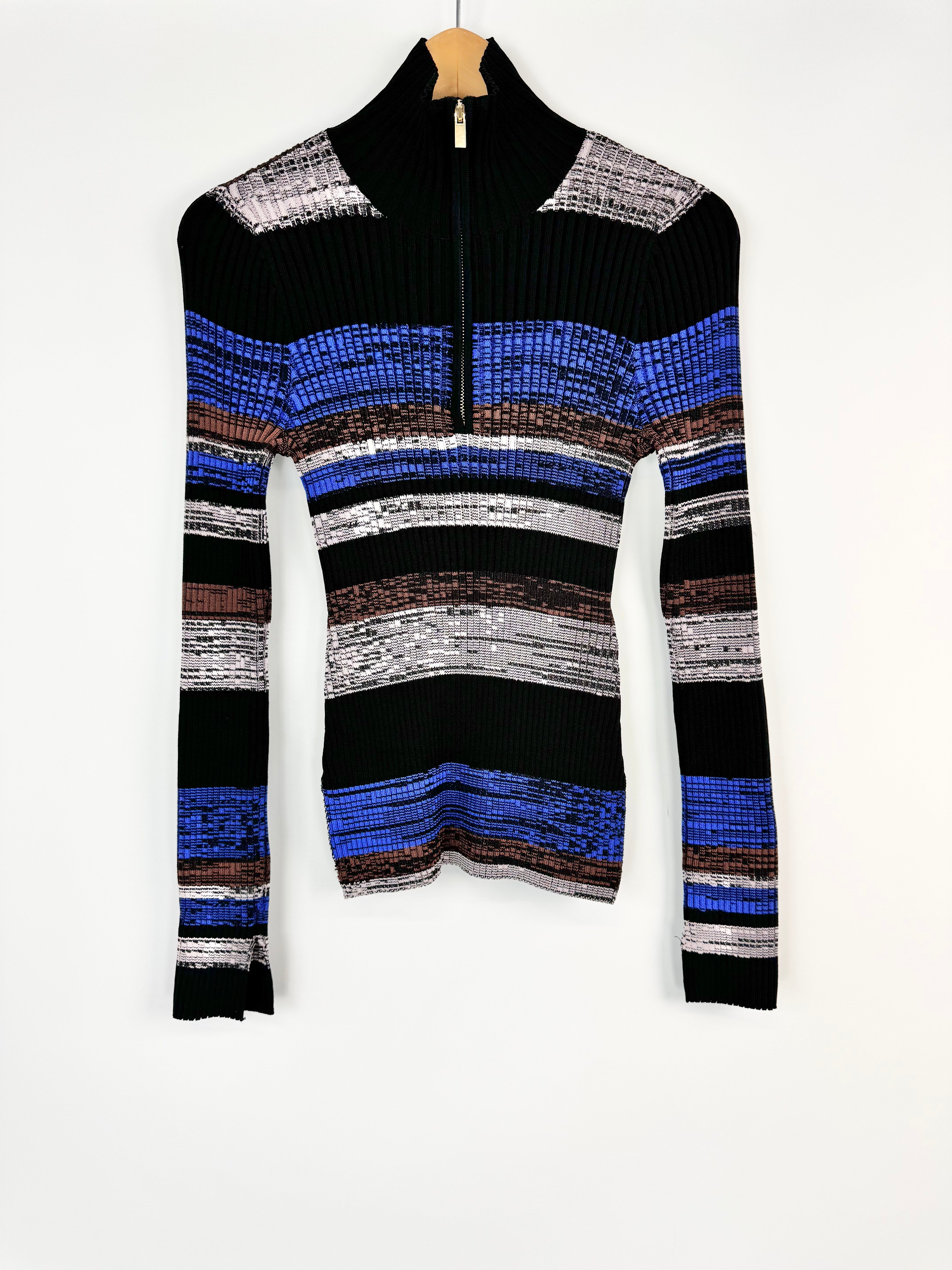 Black sweater with colorful striped pattern on a white background