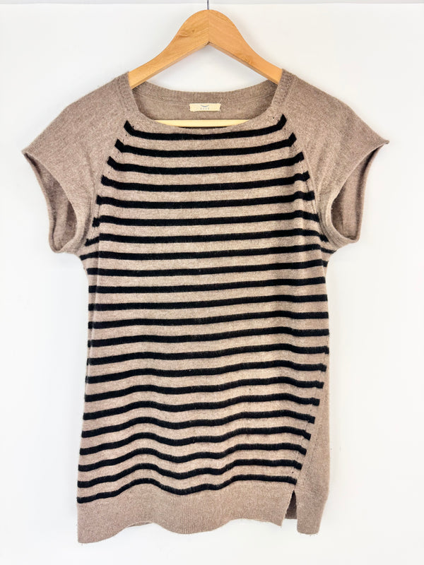 Striped shirt with beige sleeves on a hanger against a white background