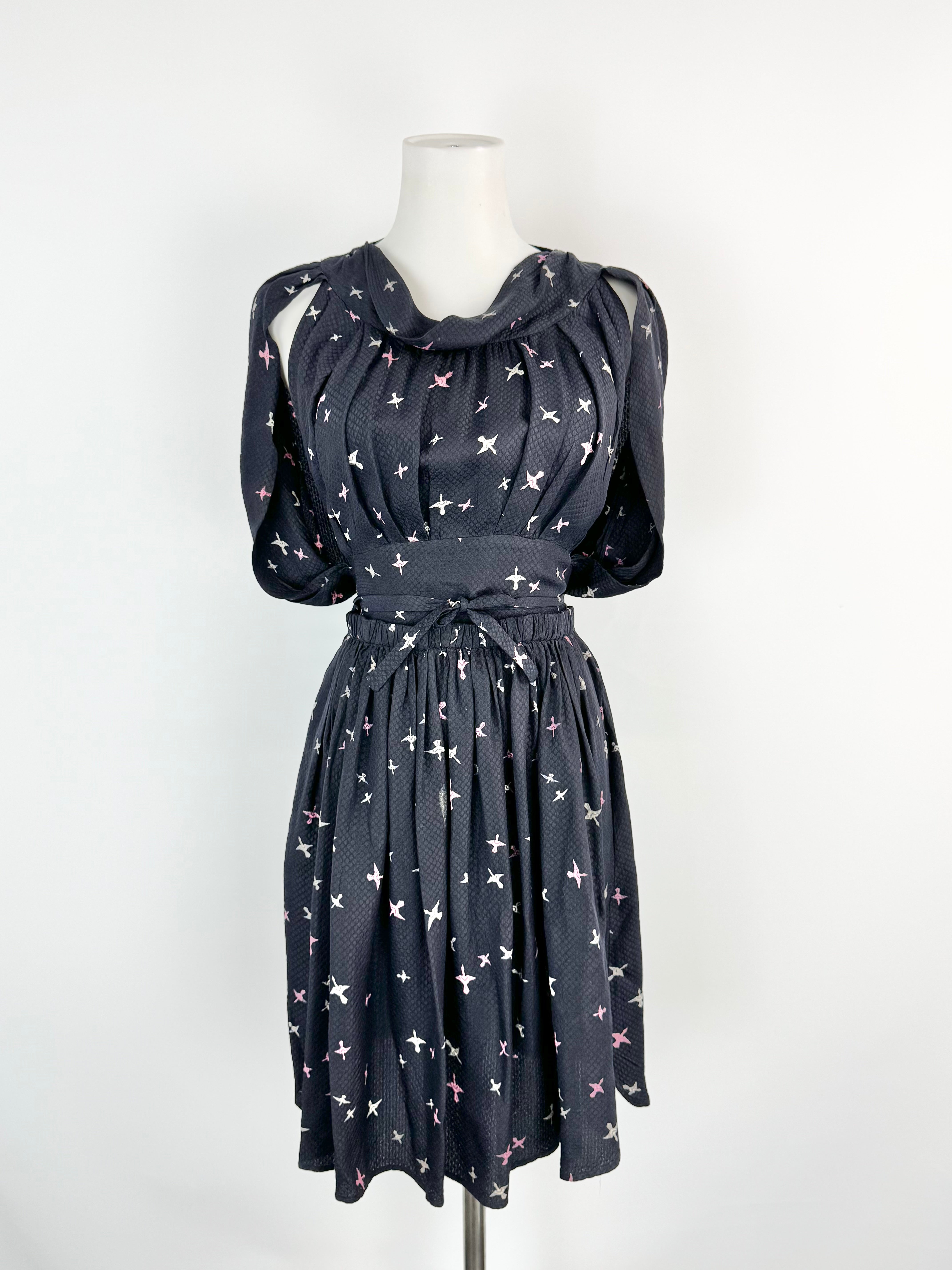 Midnight blue dress with white star pattern on a mannequin against a white background