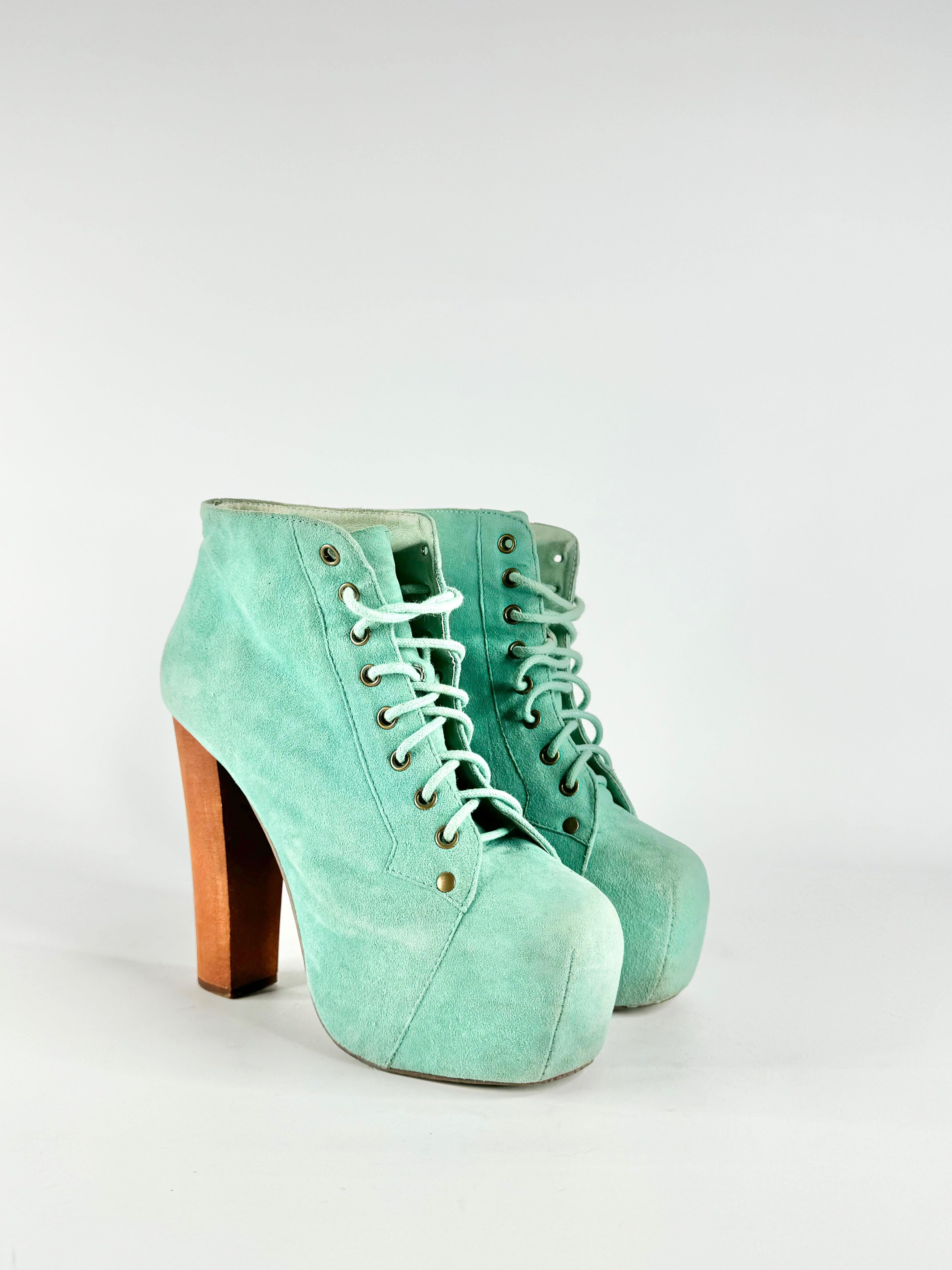 A pair of seafoam blue, suede Jeffrey Campbell Lita boots with green zippers, displayed against a plain background.