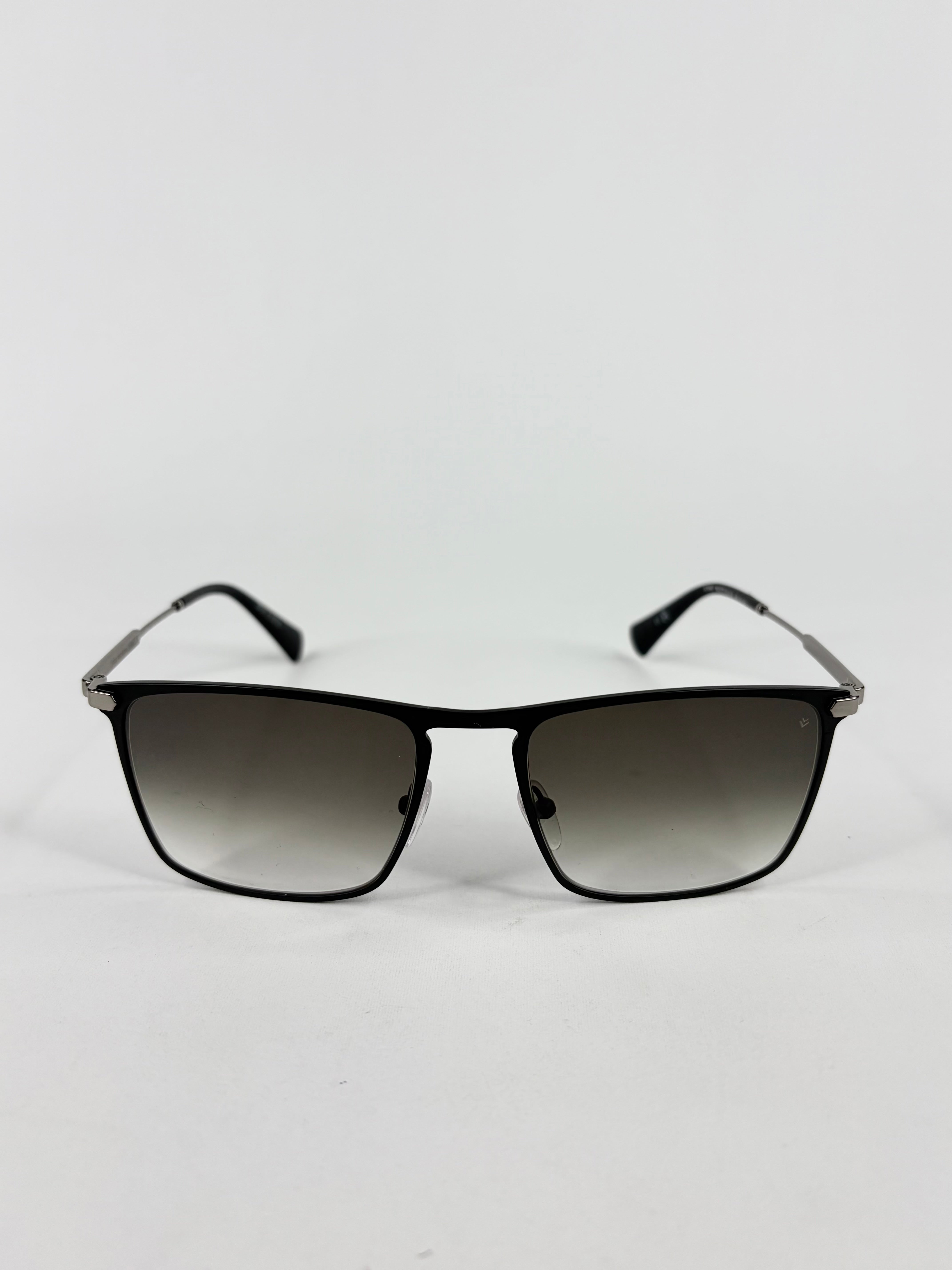 Sunglasses with black gradient lenses on a light gray background