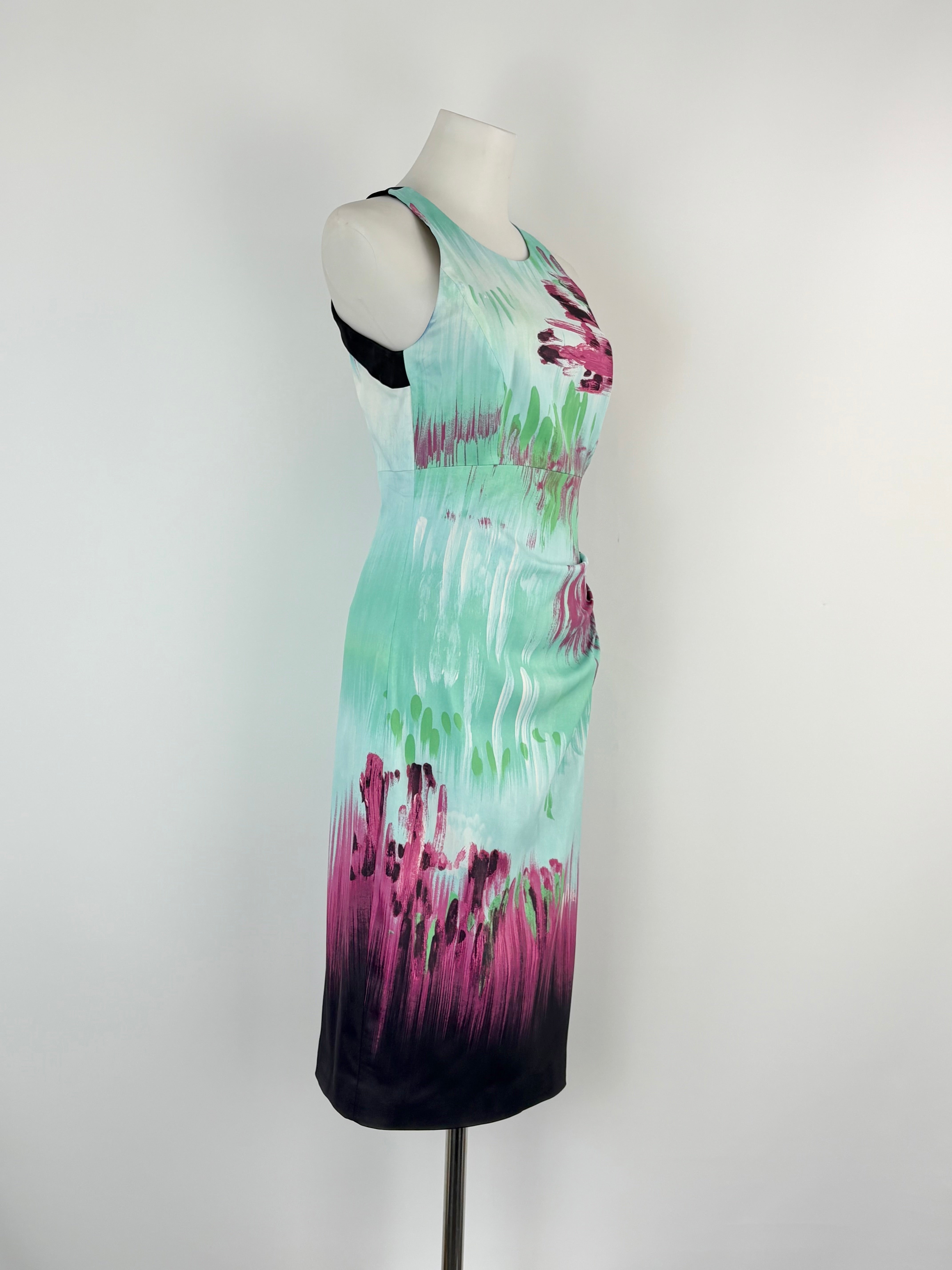 Mannequin wearing a sleeveless dress with a tie-dye design on a white background