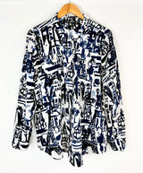 Patterned shirt on a hanger against a white background