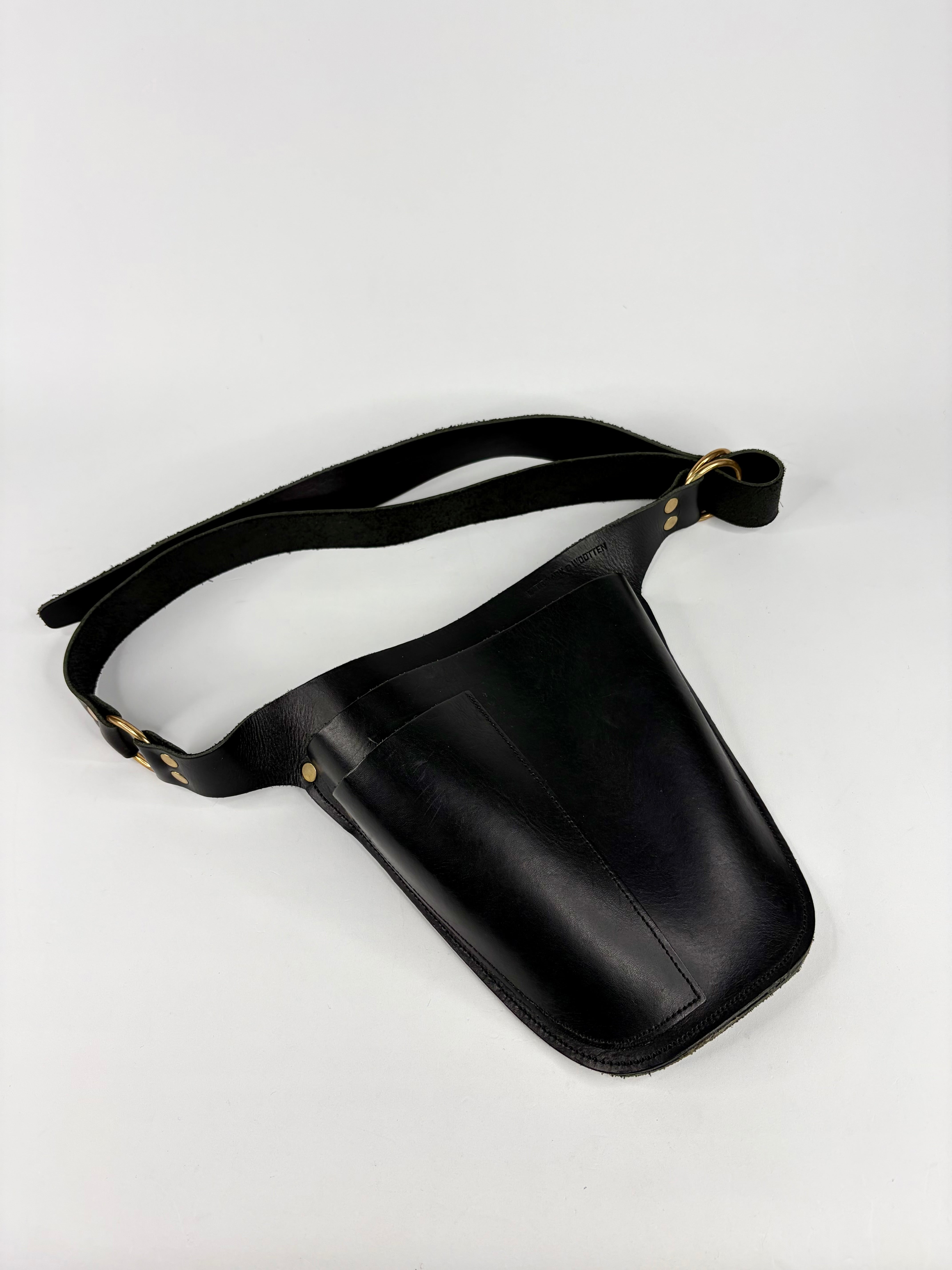 Black leather waist bag with a strap on a white background