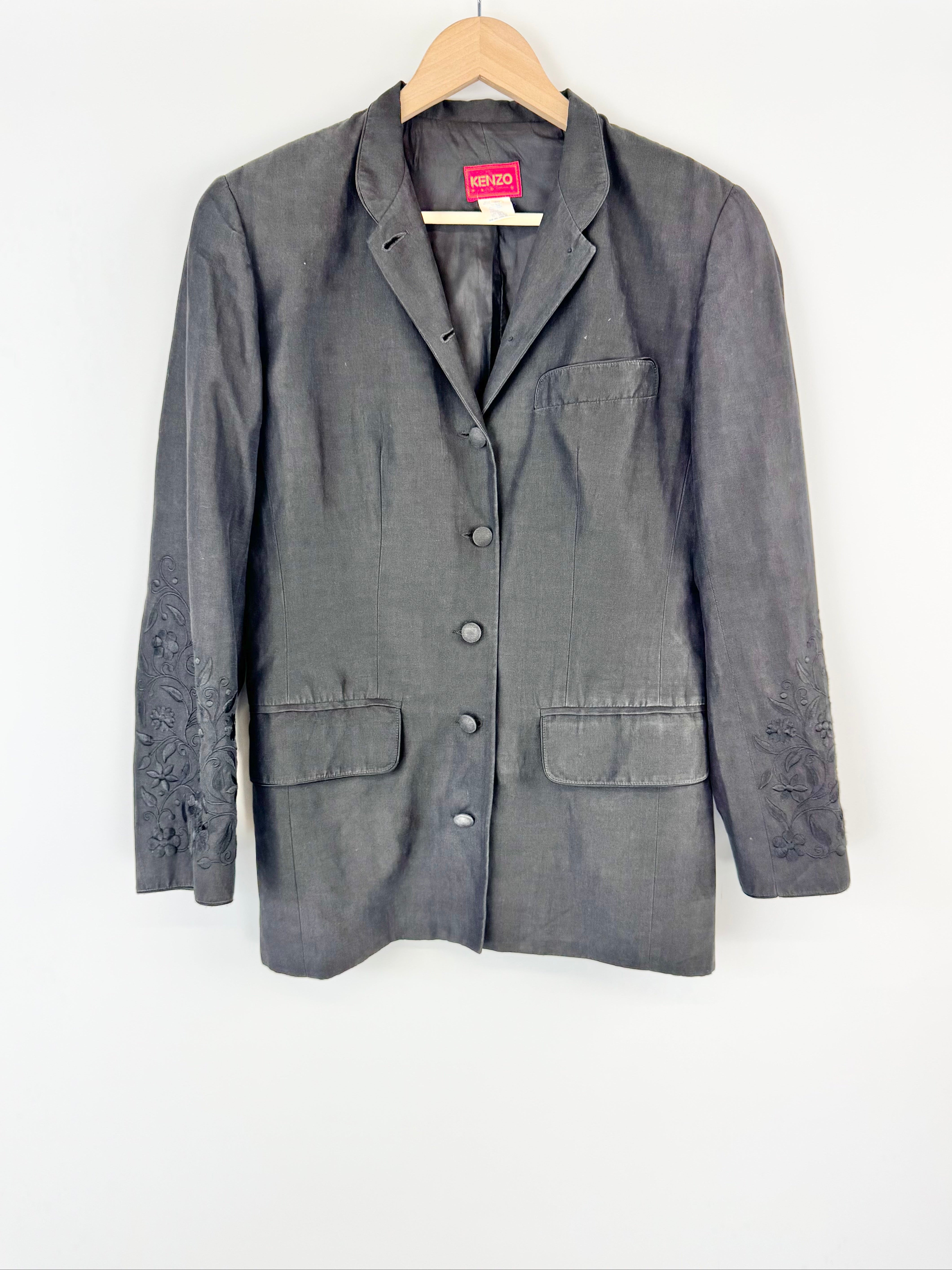 Gray jacket on a hanger against a white background