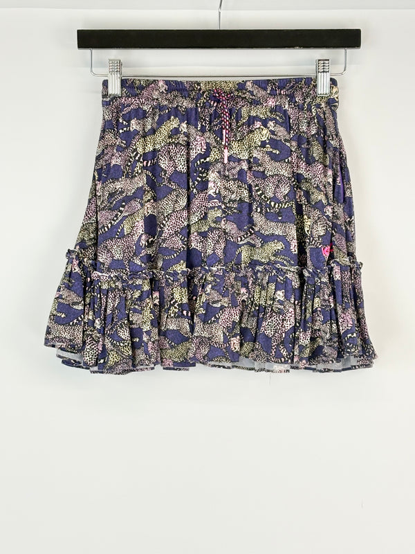 Floral patterned skirt on a hanger against a white background
