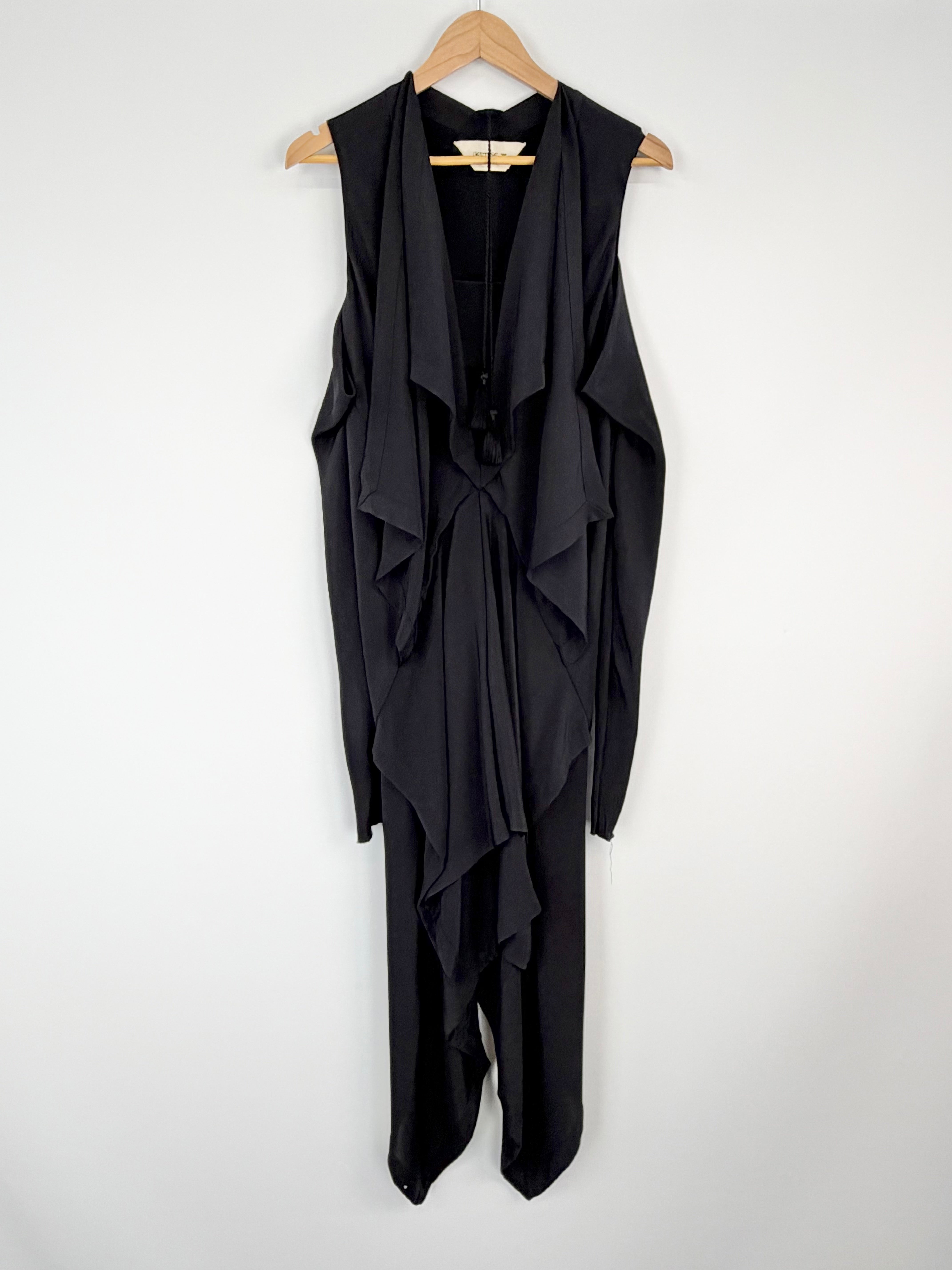 Black sleeveless dress with draped design on a hanger against a white background