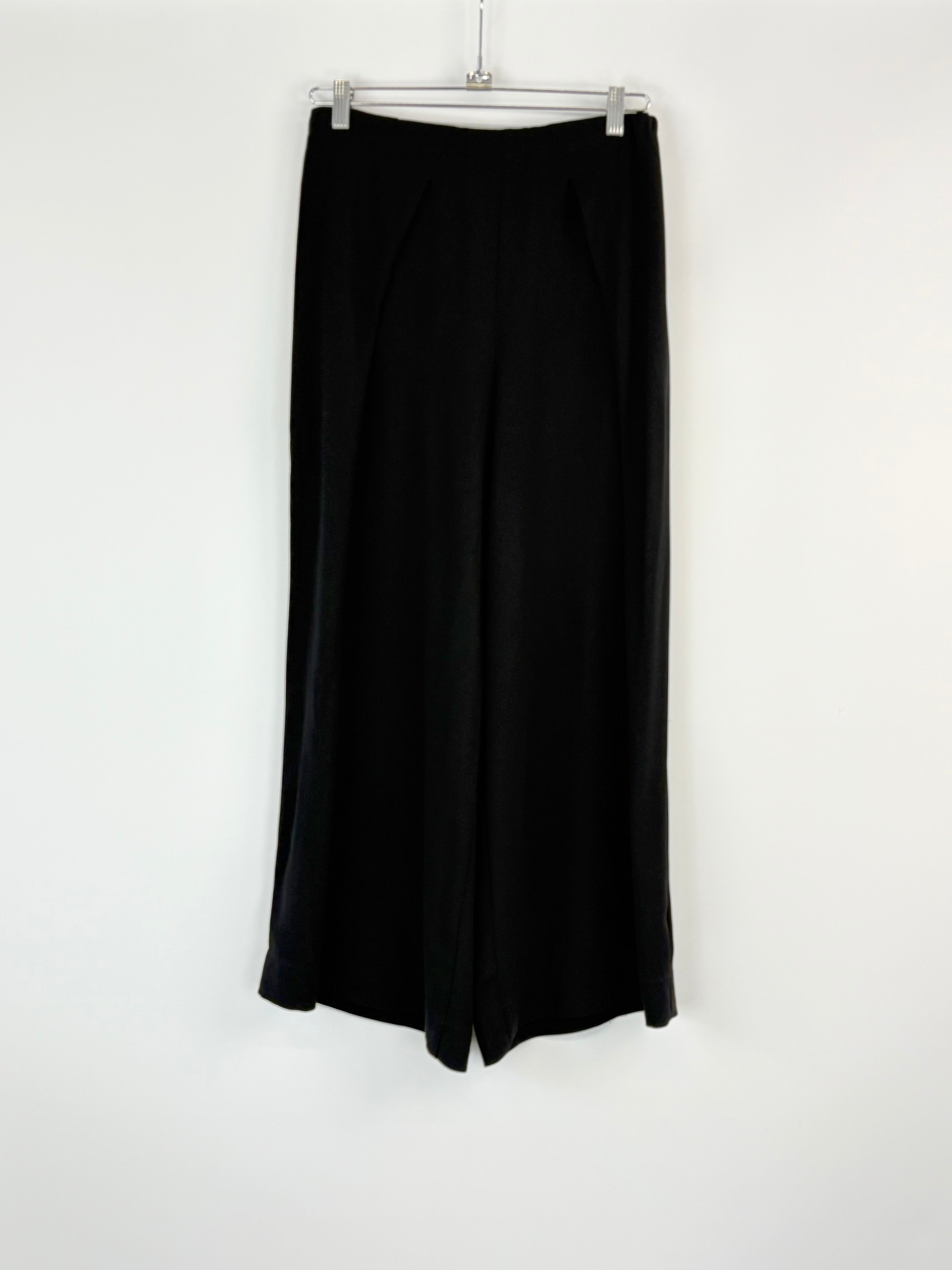 Black skirt hanging on a white background