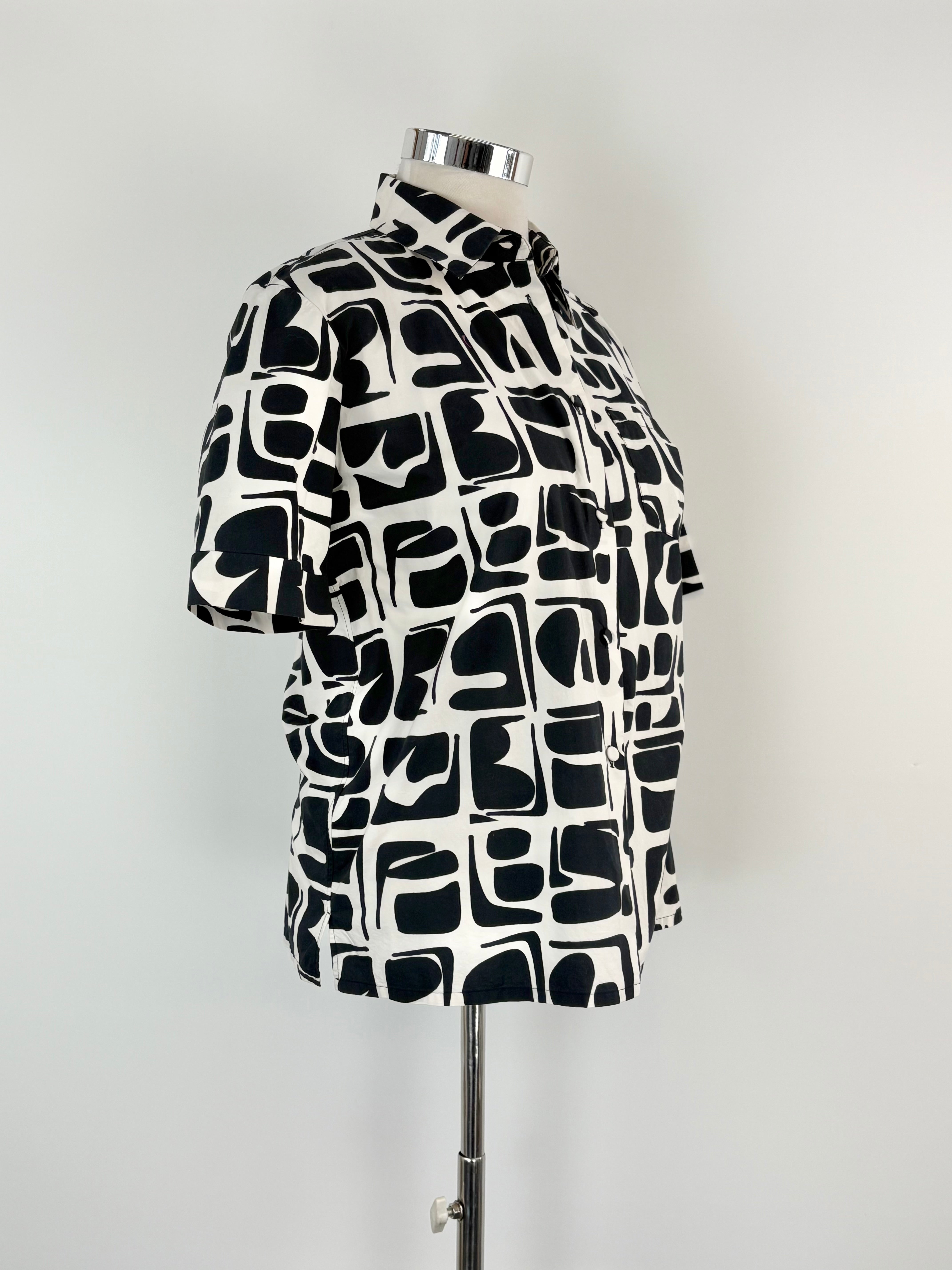 Black and white patterned shirt on a mannequin against a white background