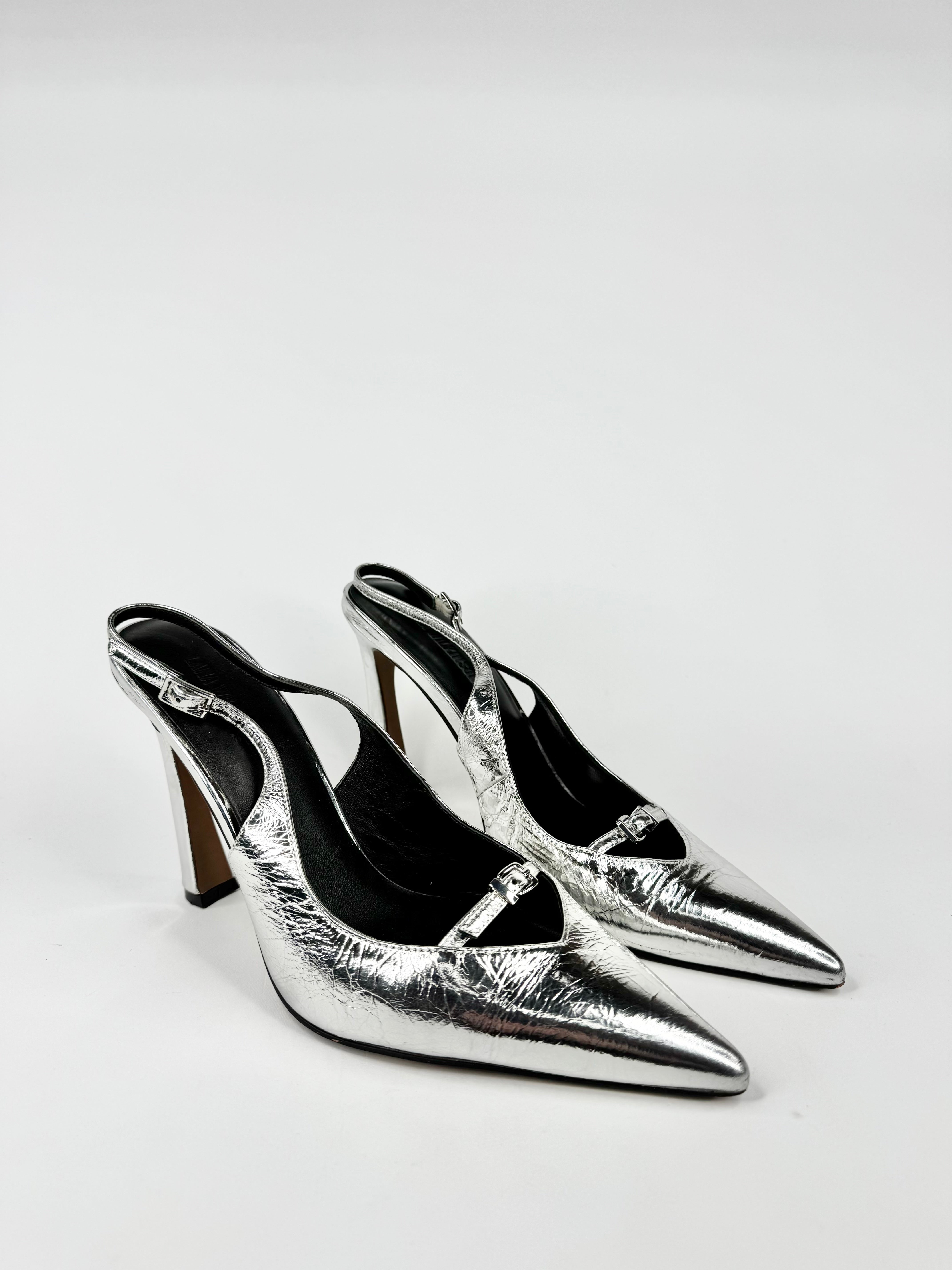 Pair of silver high-heeled shoes on a white background