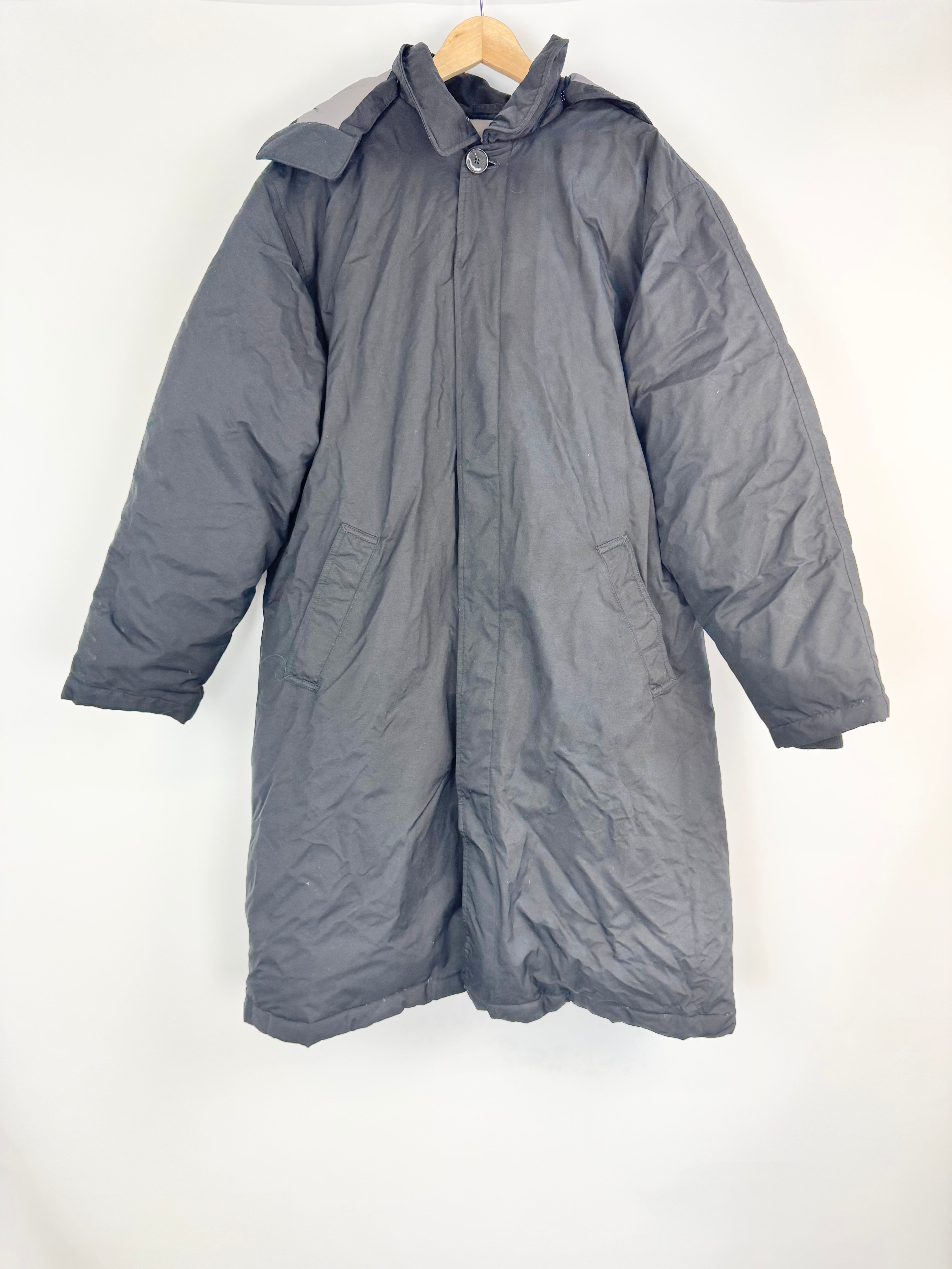 Black Puffer Jacket on a wooden hanger against a white background