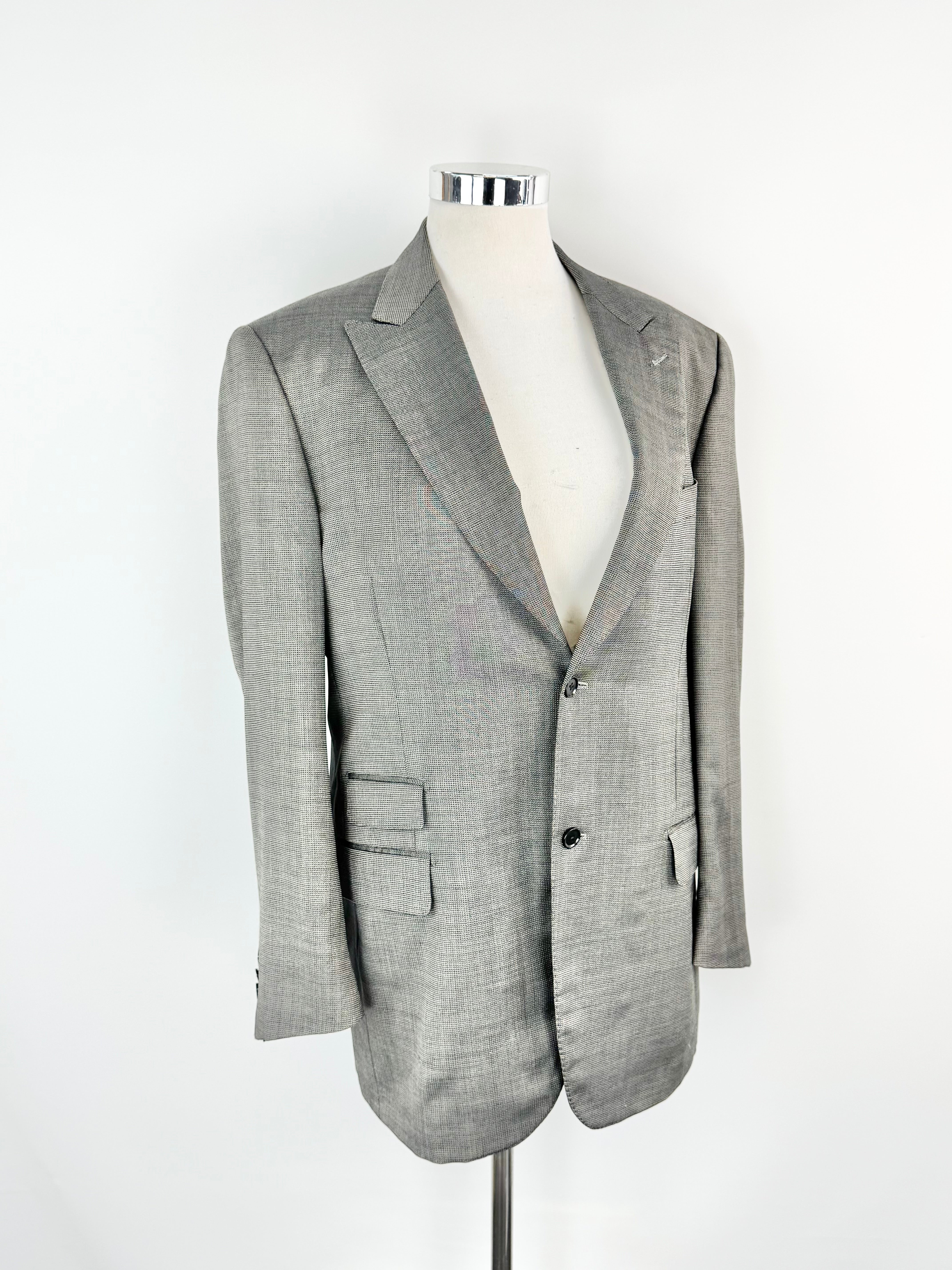 Gray blazer on a mannequin against a white background