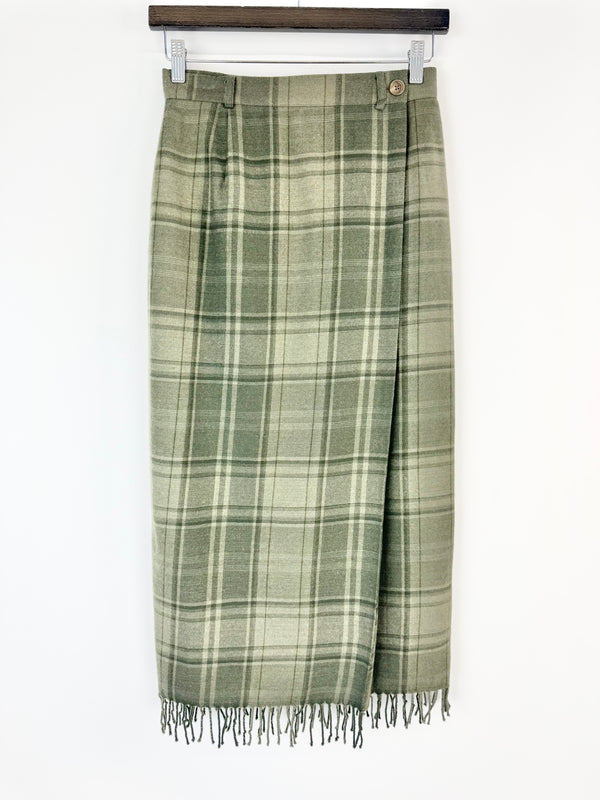 Green plaid skirt with fringe on a white background