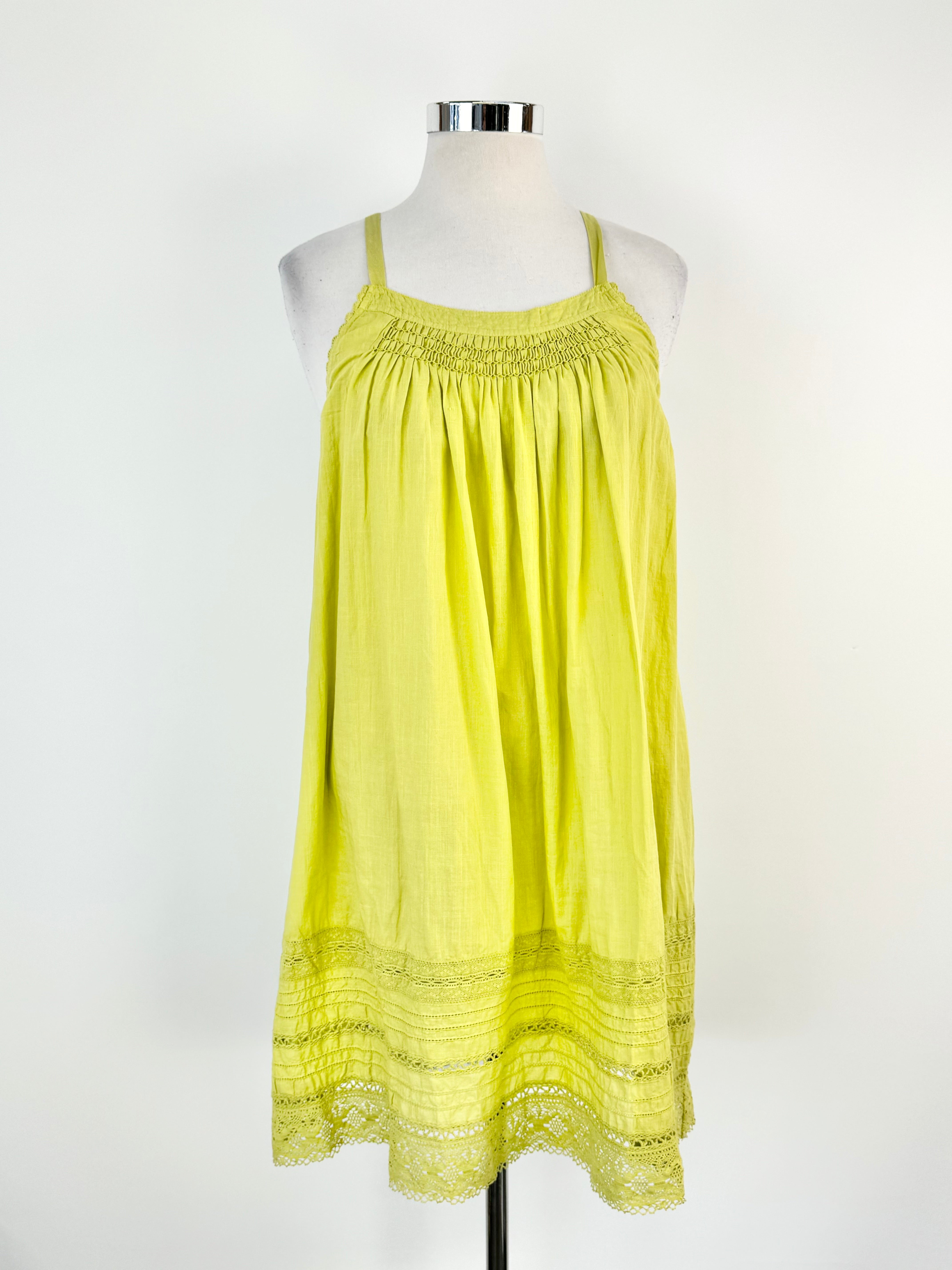 A Lee Mathews apple green linen shift dress displayed on a mannequin, featuring medium wide straps, lace trim, and a shirred section at the bust.